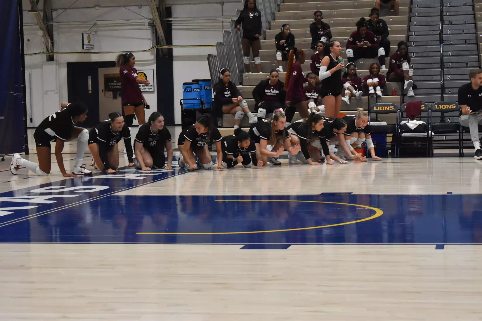 The bench smacks the court to hype up the team on the floor.