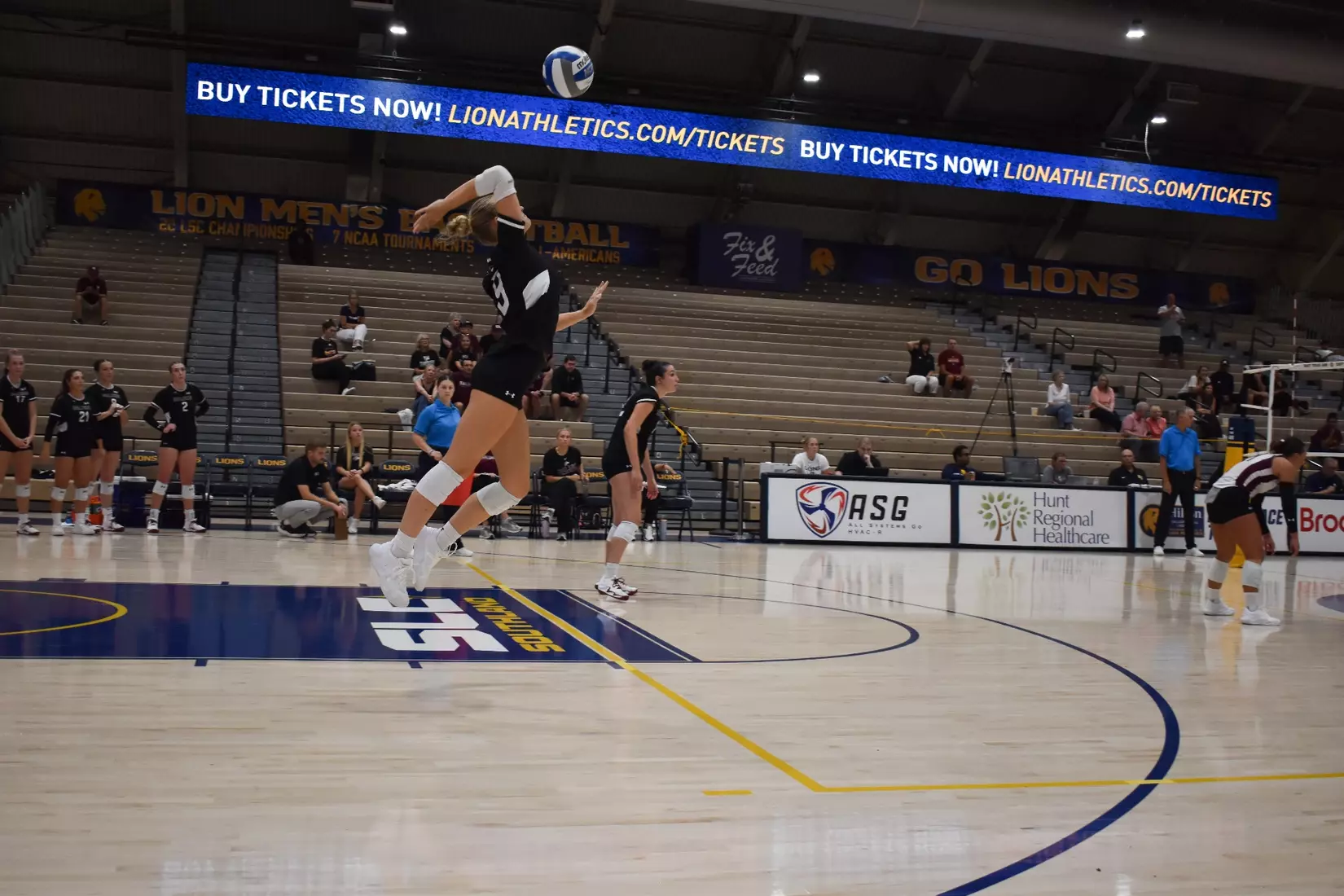 Lillian Dempkey serves a ball in the match.