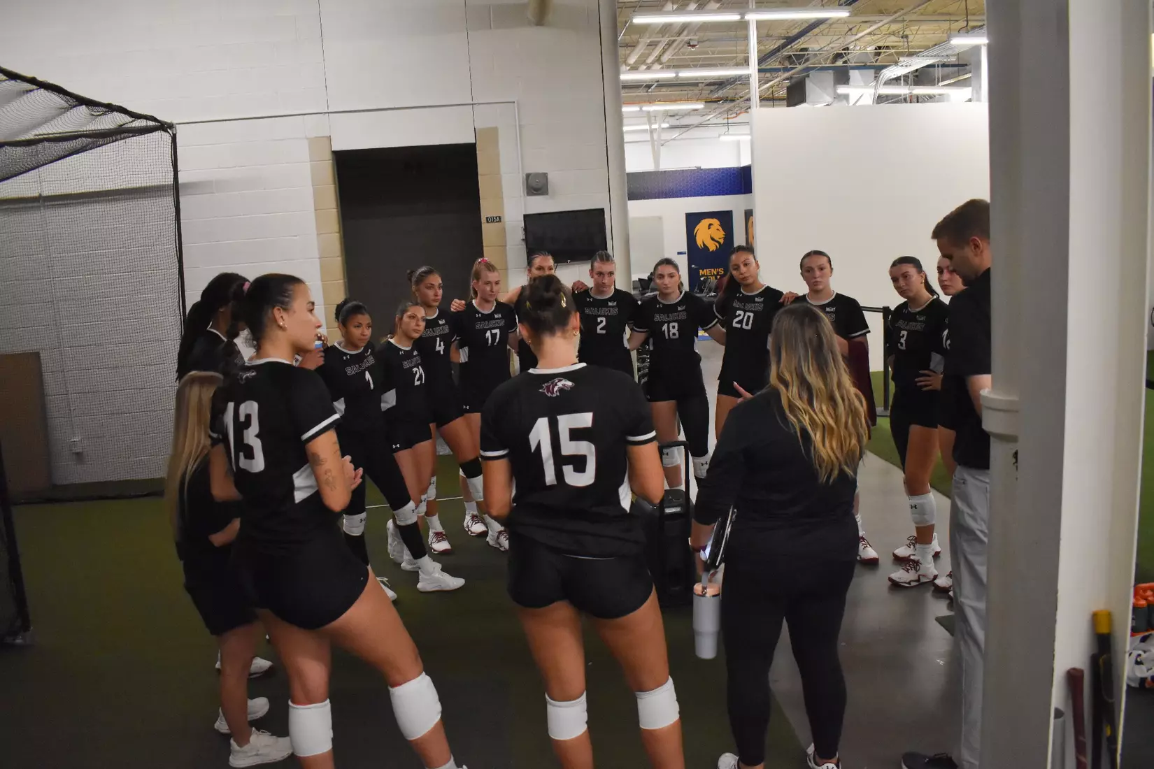 Head Coach Brittany Harry talks with the team postgame.