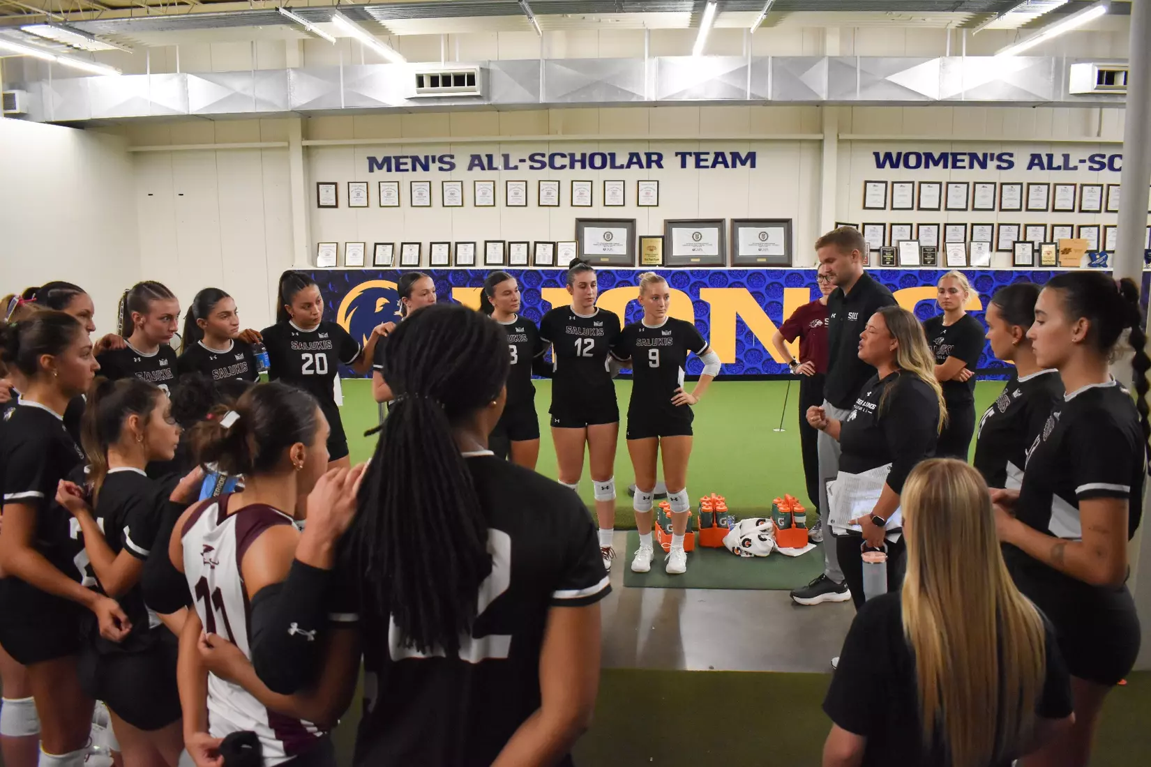 Head Coach Brittany Harry talks with the team postgame.