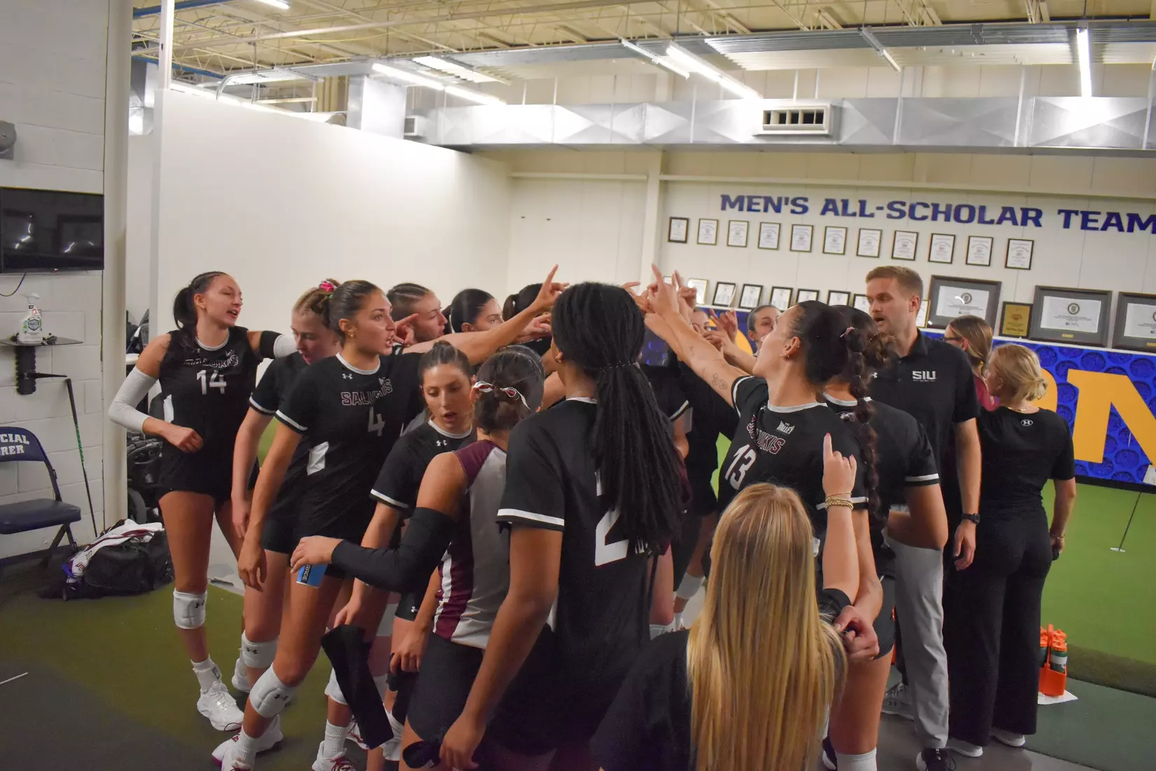 The team breaks down a huddle in the locker room postgame.