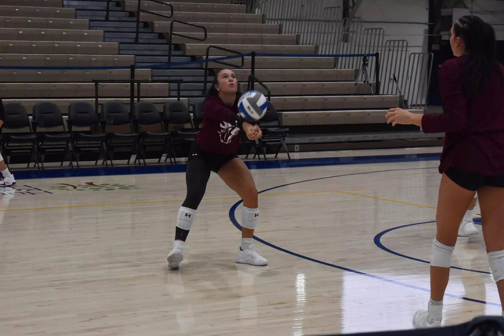 McKenzie Moeller bumps a ball in warmups.