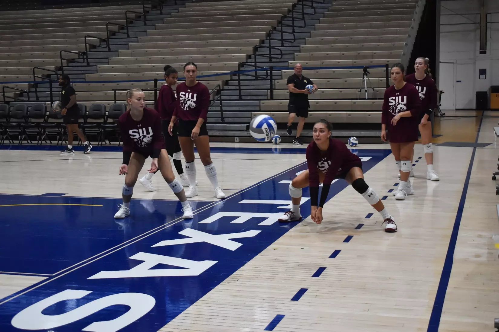 Ella McFarland prepares to receive a ball in warmups.