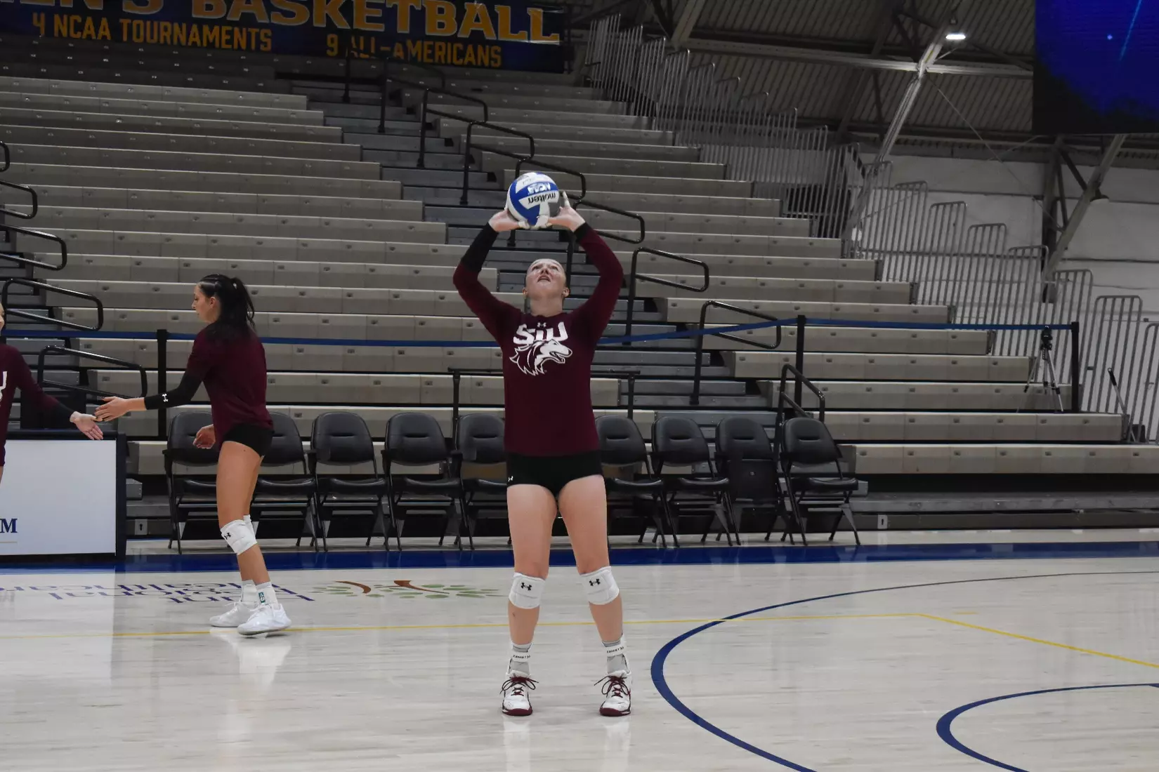 Alexandria Arrington sets a ball in warmups.