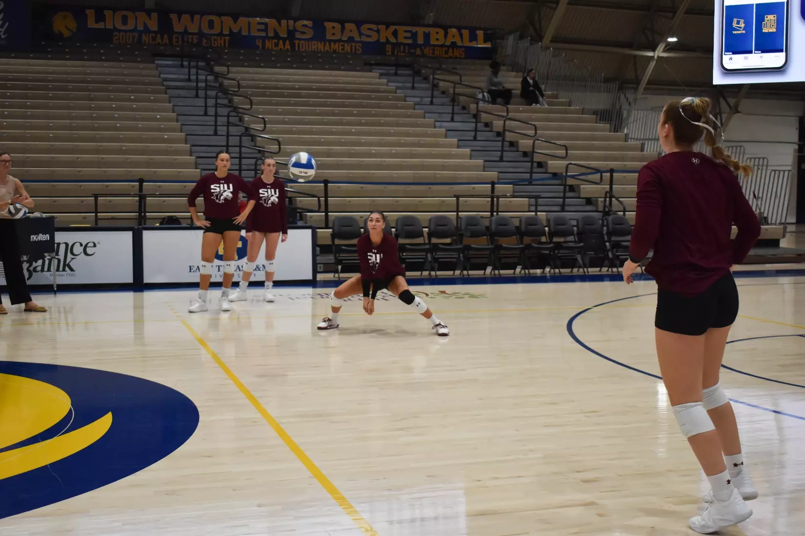 Ella McFarland prepares to receive a ball in warmups.