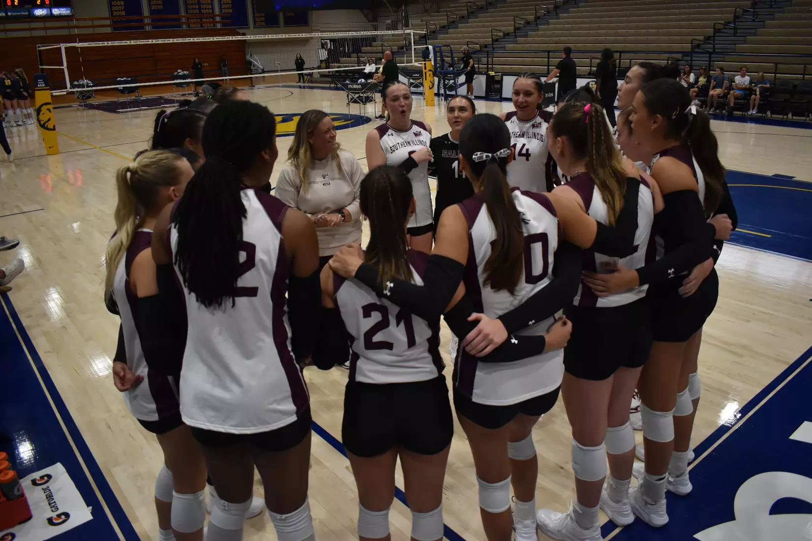 Head Coach Brittany Harry talks to the team prior to the start of the match.