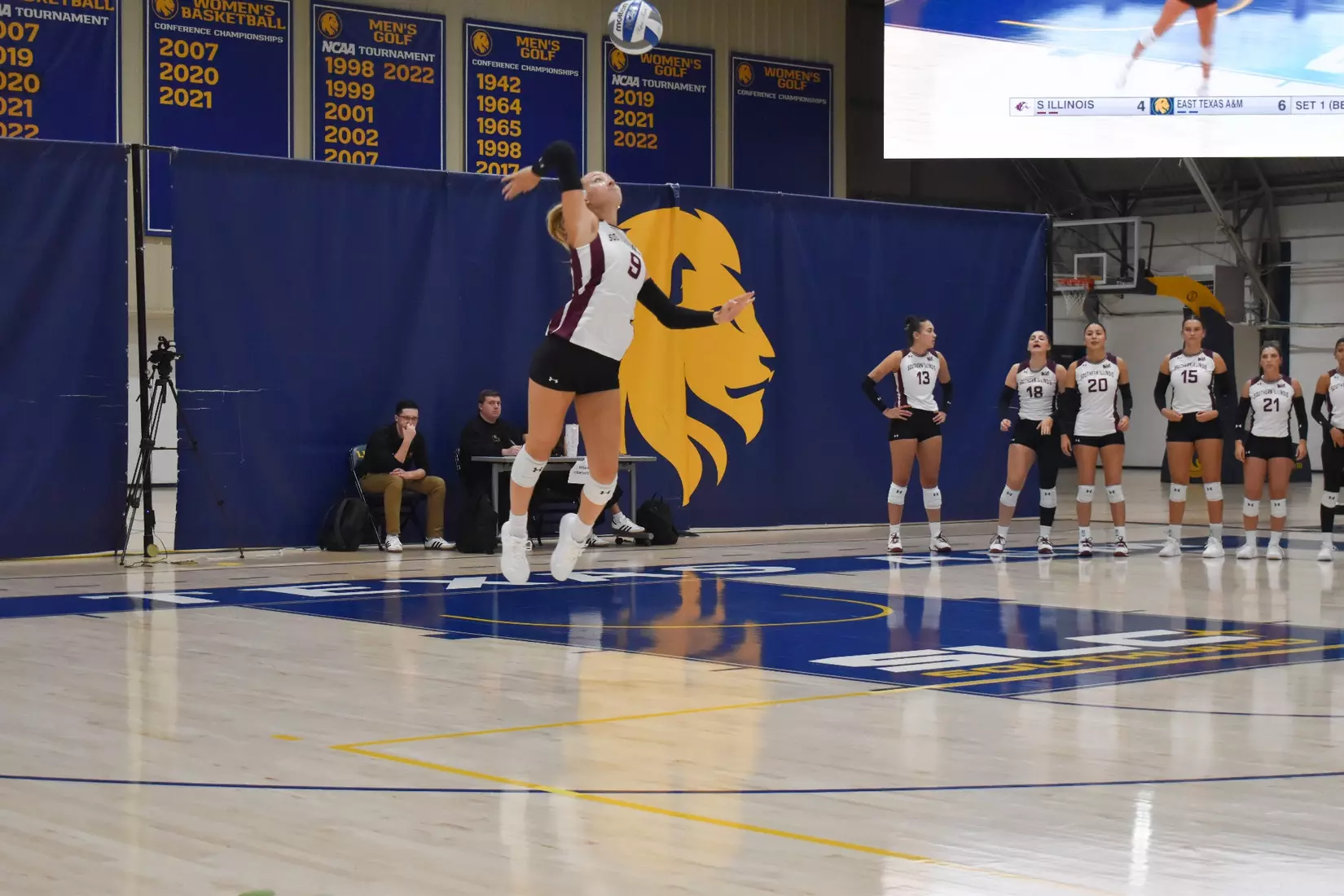 Lillian Dempkey serves a ball in the match.