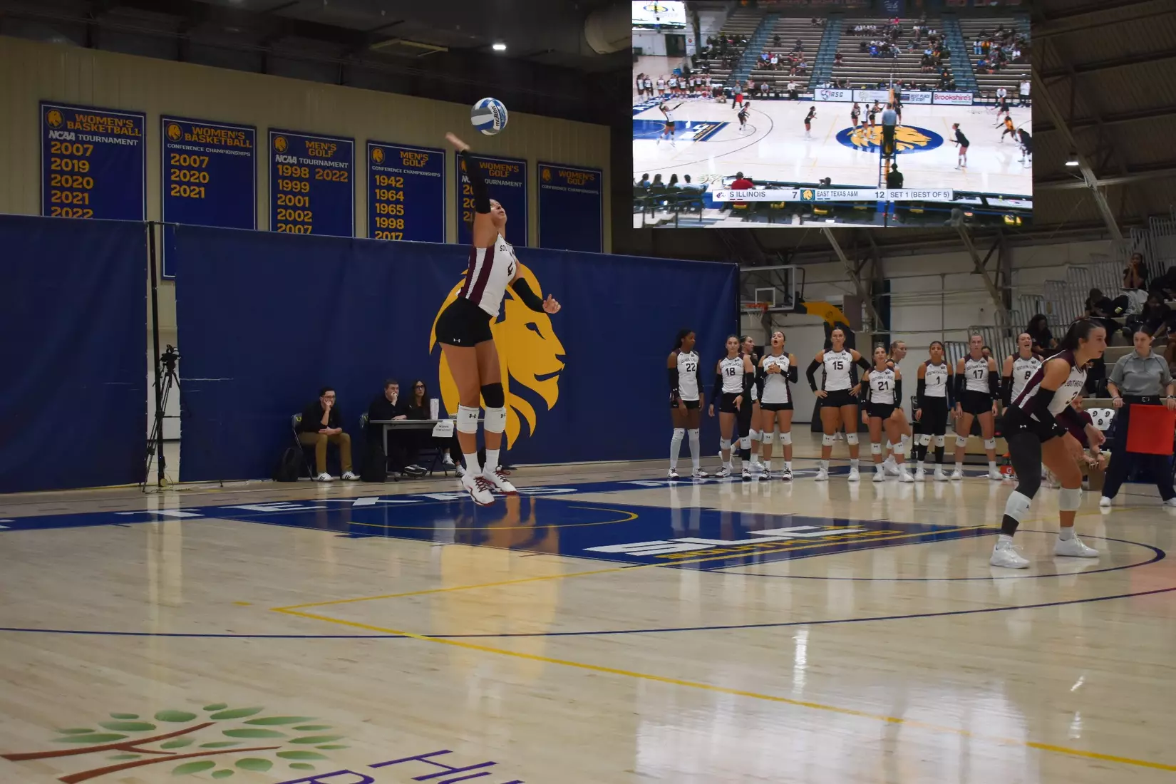 Ella McFarland serves a ball.