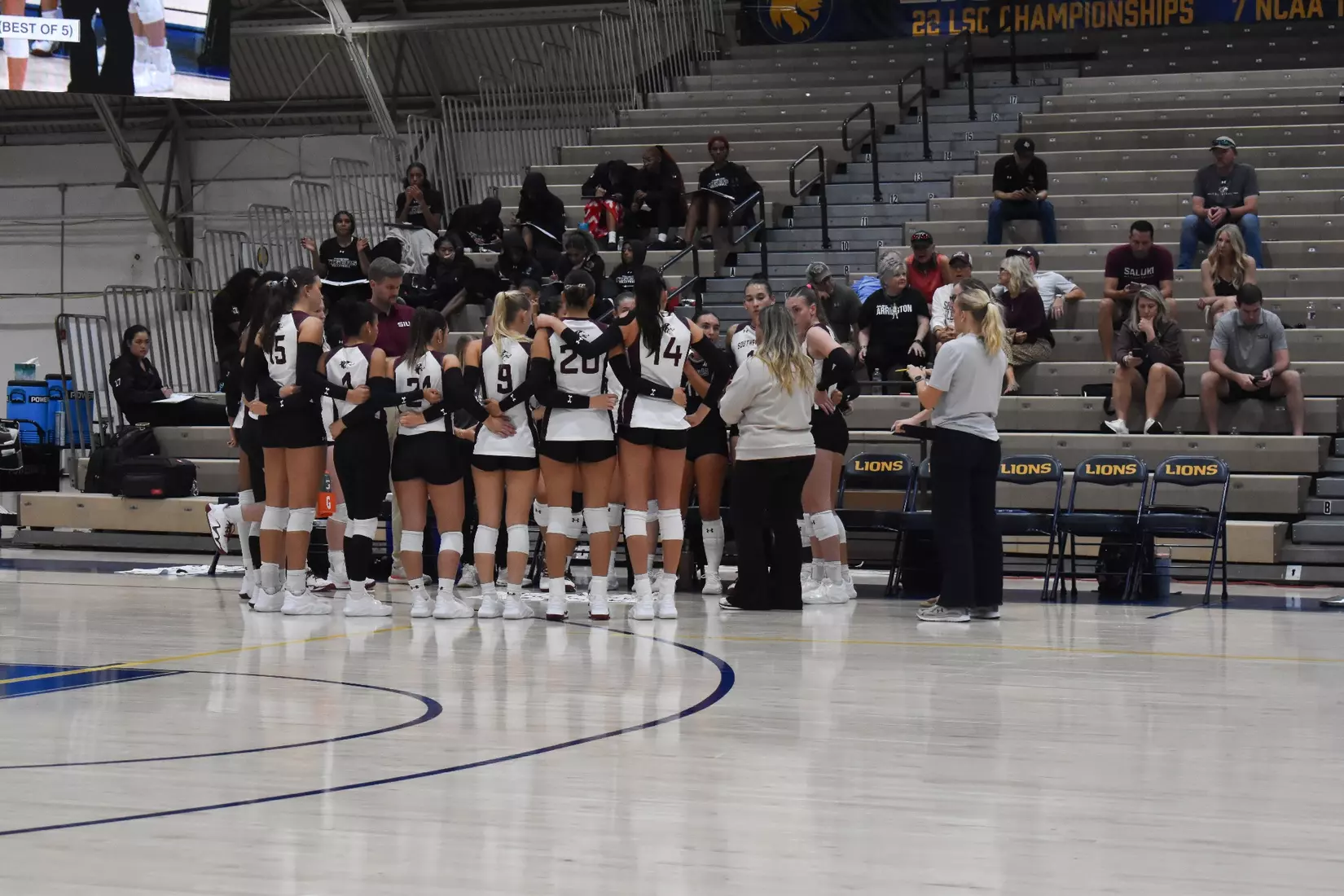 Head Coach Brittany Harry talks to her team during a timeout.