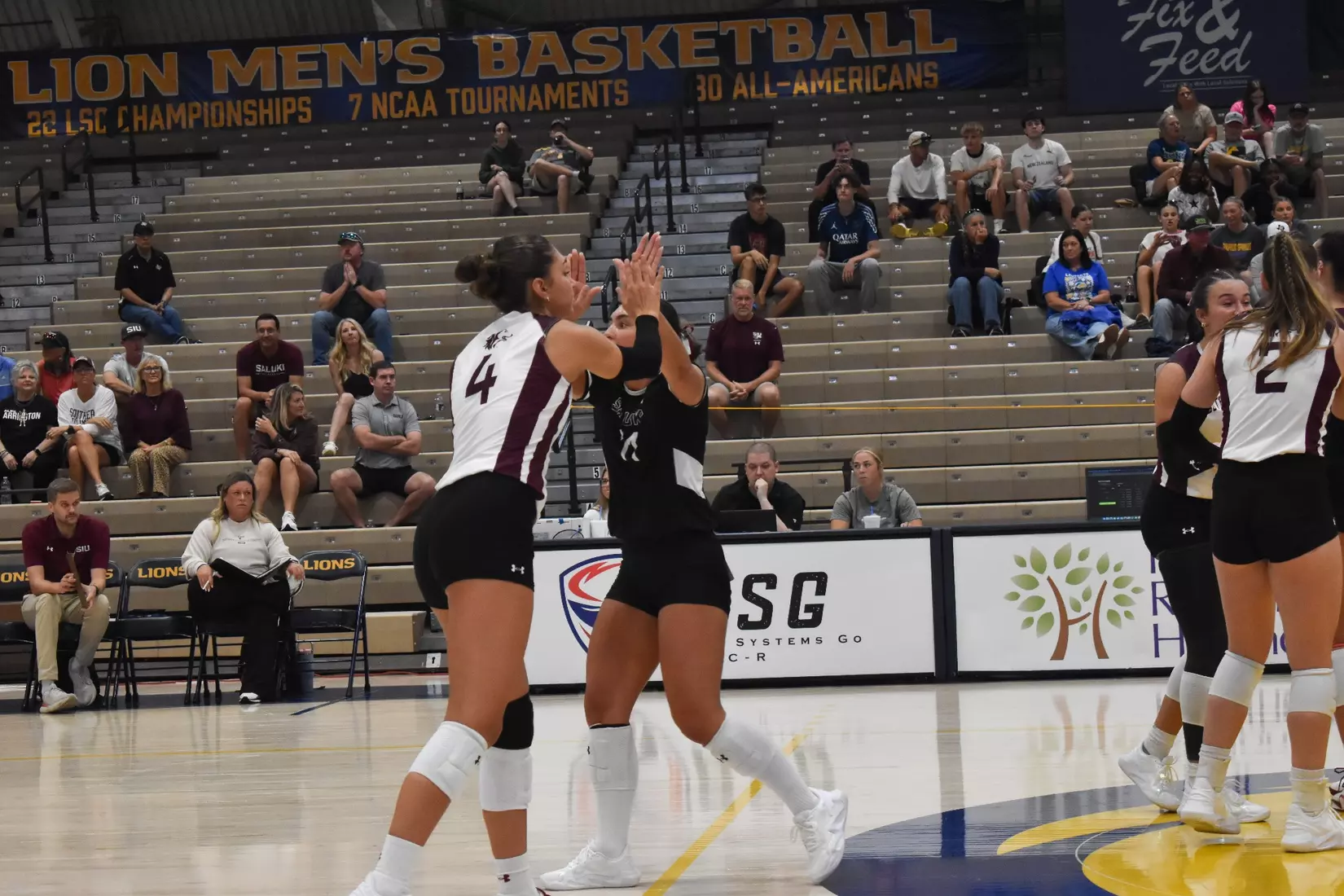Jillian Shaneyfelt and Ella McFarland high five after a point.