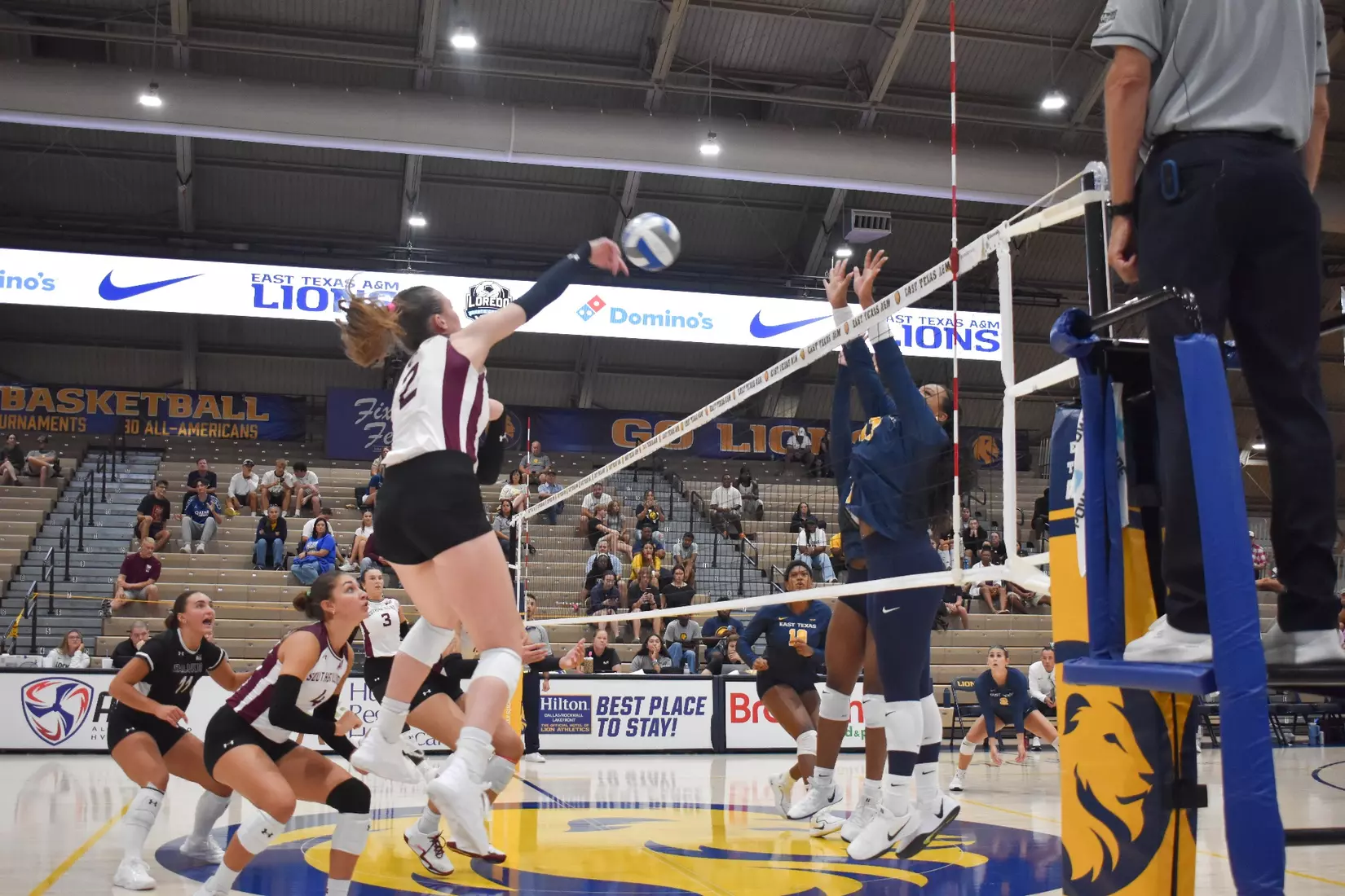 Natalie Vance spikes a ball over the net.