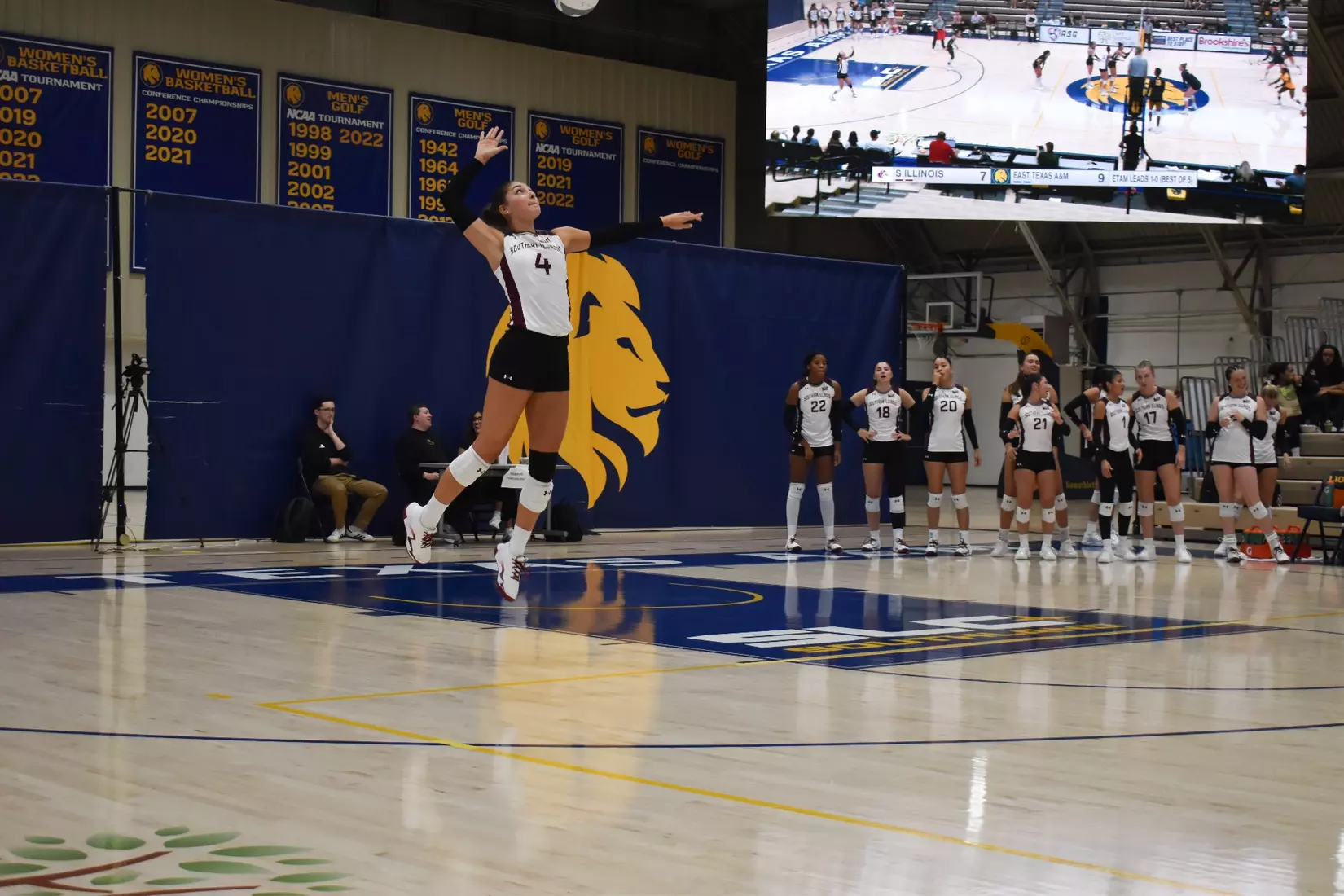 Ella McFarland jumps up for a serve.