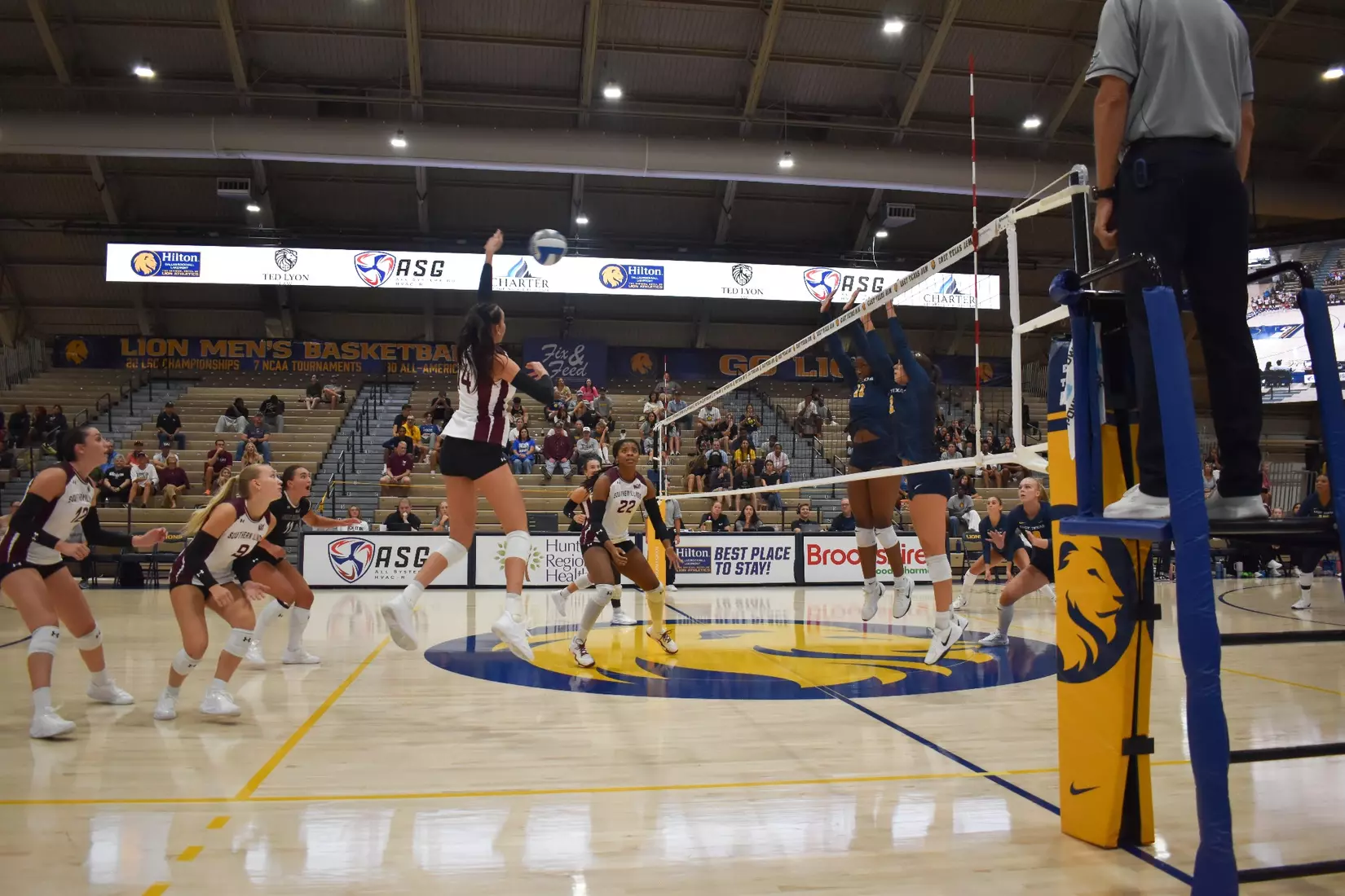 Ella Swansiger jumps up to smack the ball over the net.