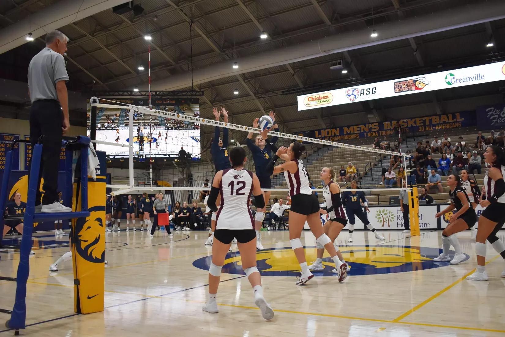 Beatriz Piaia tips a ball over the blocker's arms.