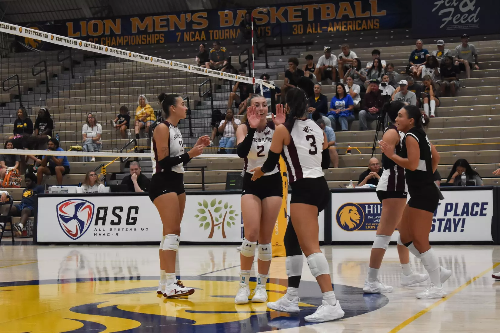Natalie Vance double high fives McKenzie Moeller after a point.