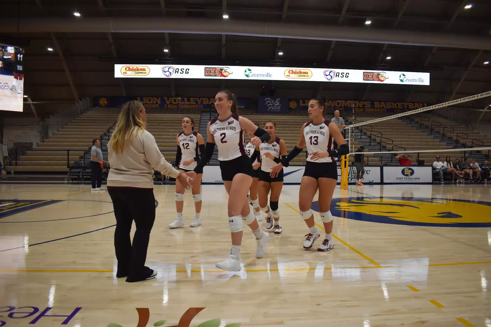 Natalie Vance high fives Head Coach Brittany Harry during a timeout.