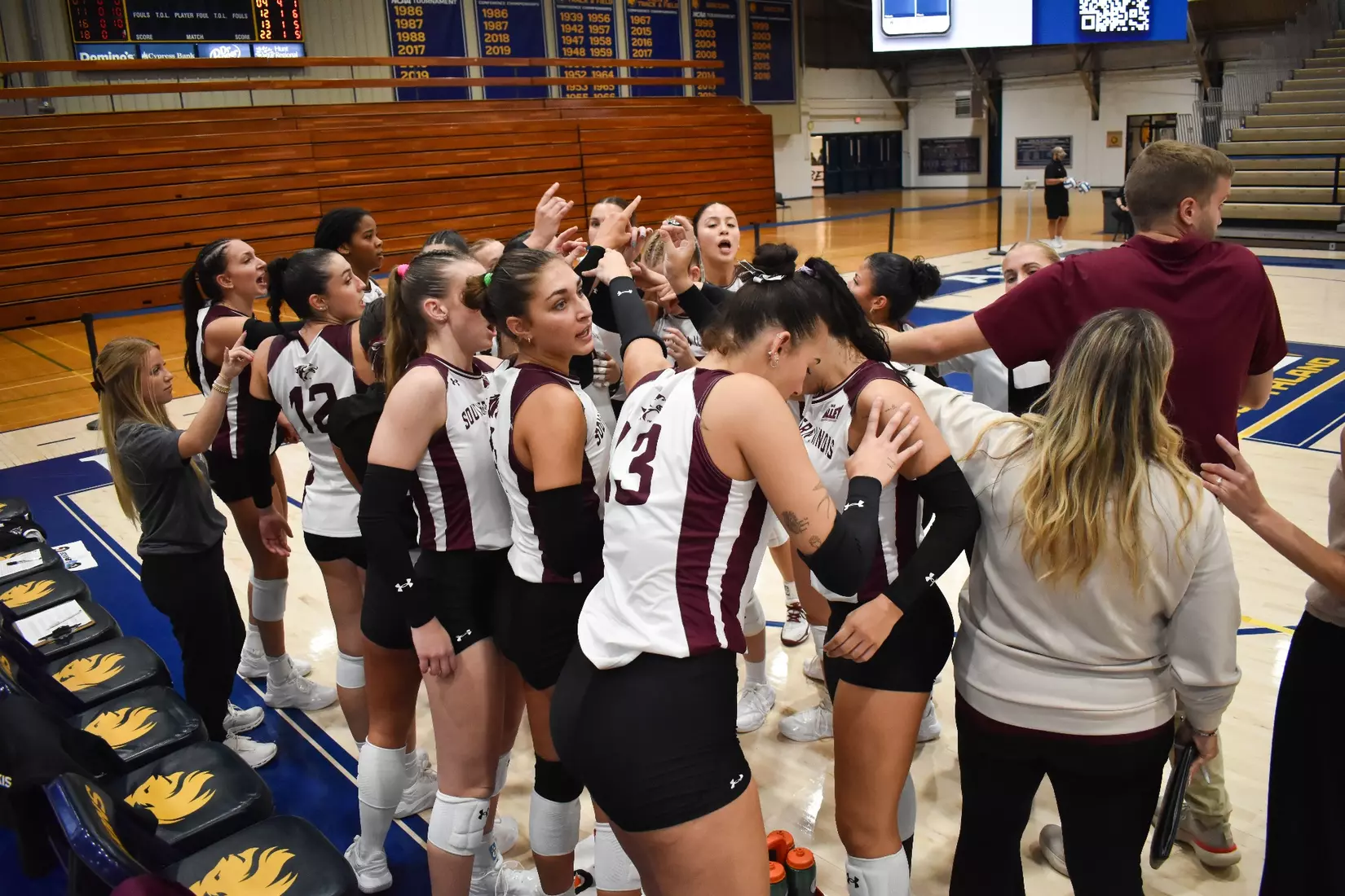 The team breaks down a huddle at the end of a timeout.