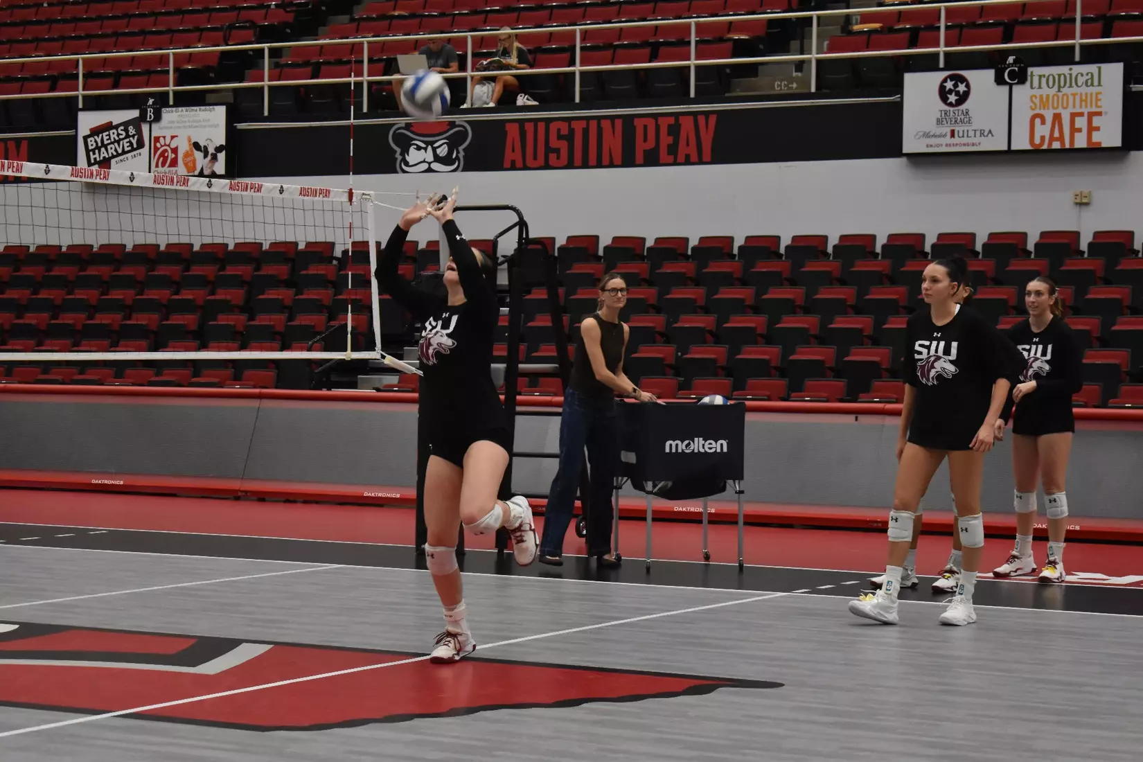 Alexandria Arrington sets a ball in warmups.