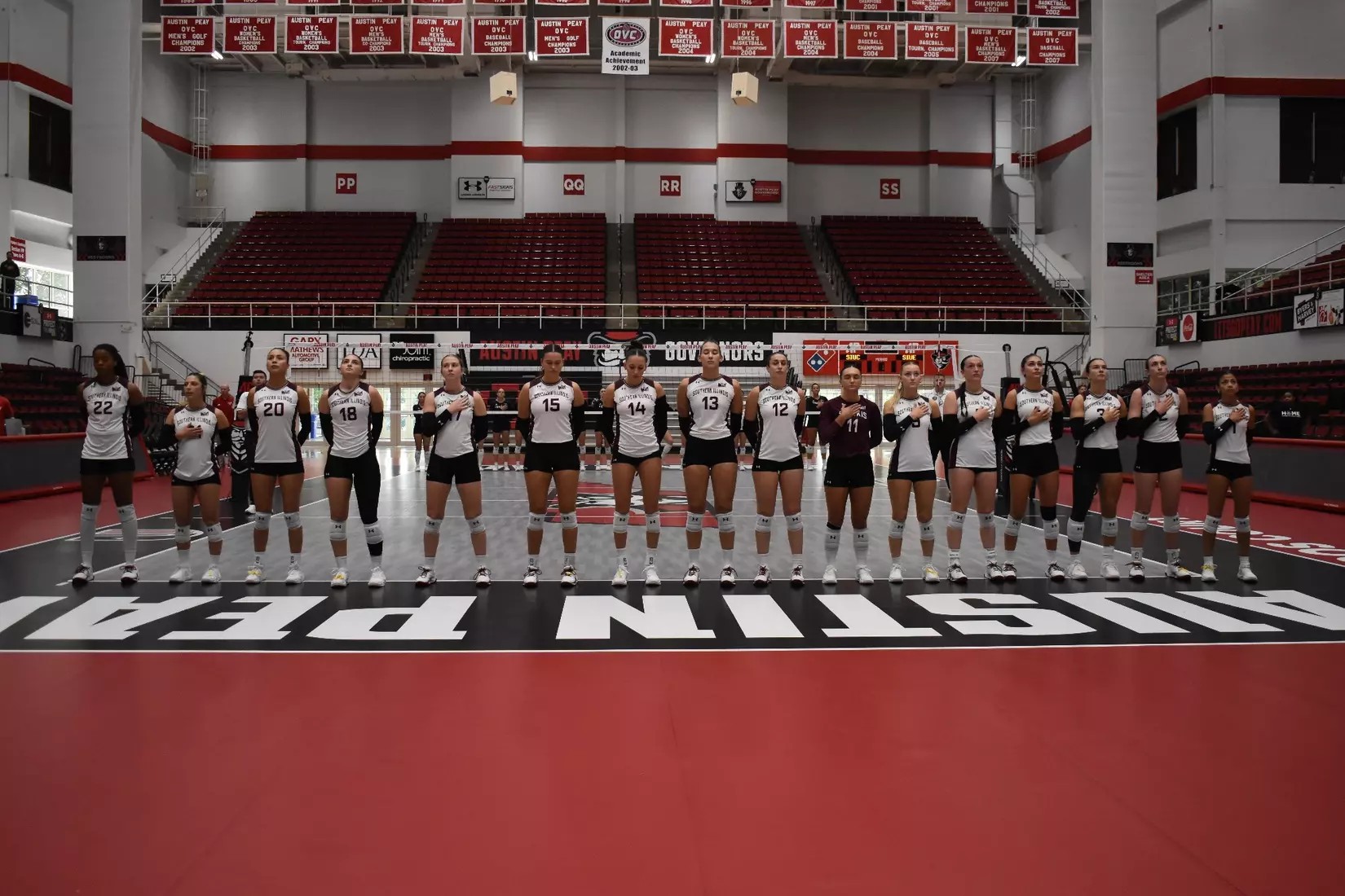 The team stands side-by-side during the National Anthem.