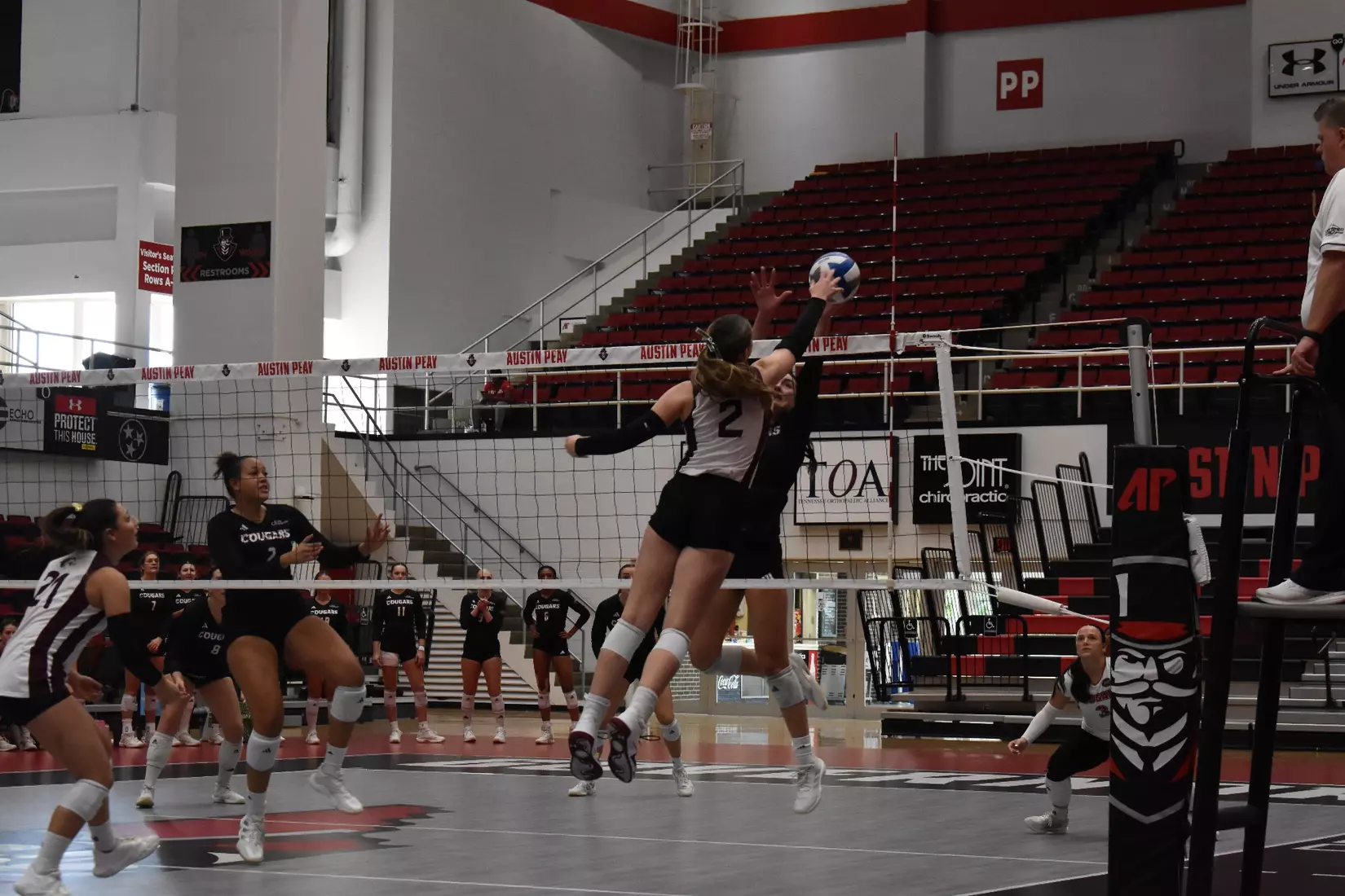 Natalie Vance tips a ball over the net.