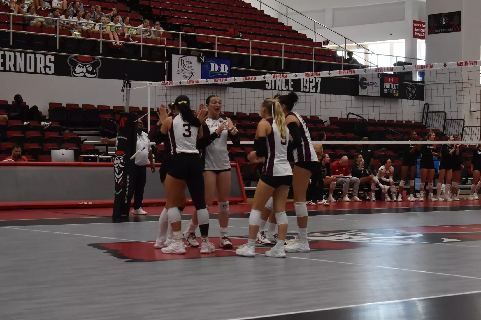 The team smiles and celebrates after a point.