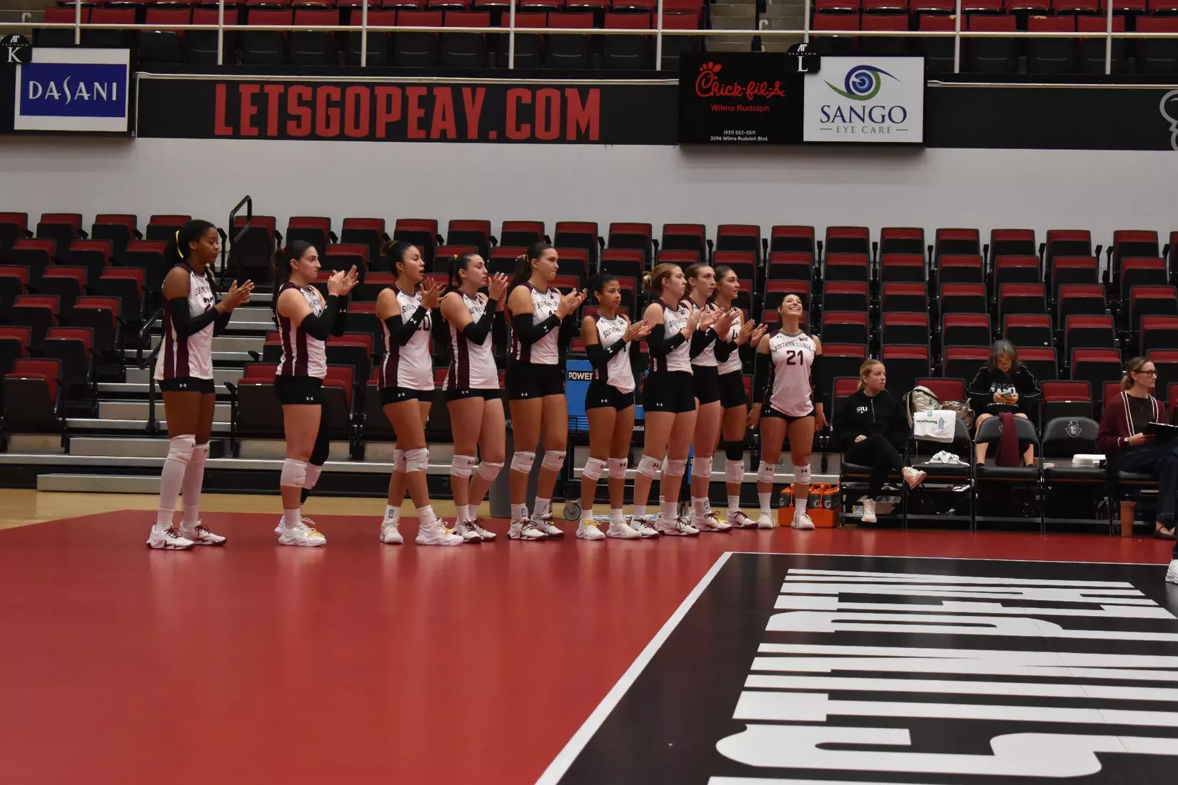 The bench claps as they hype up the team on the court.