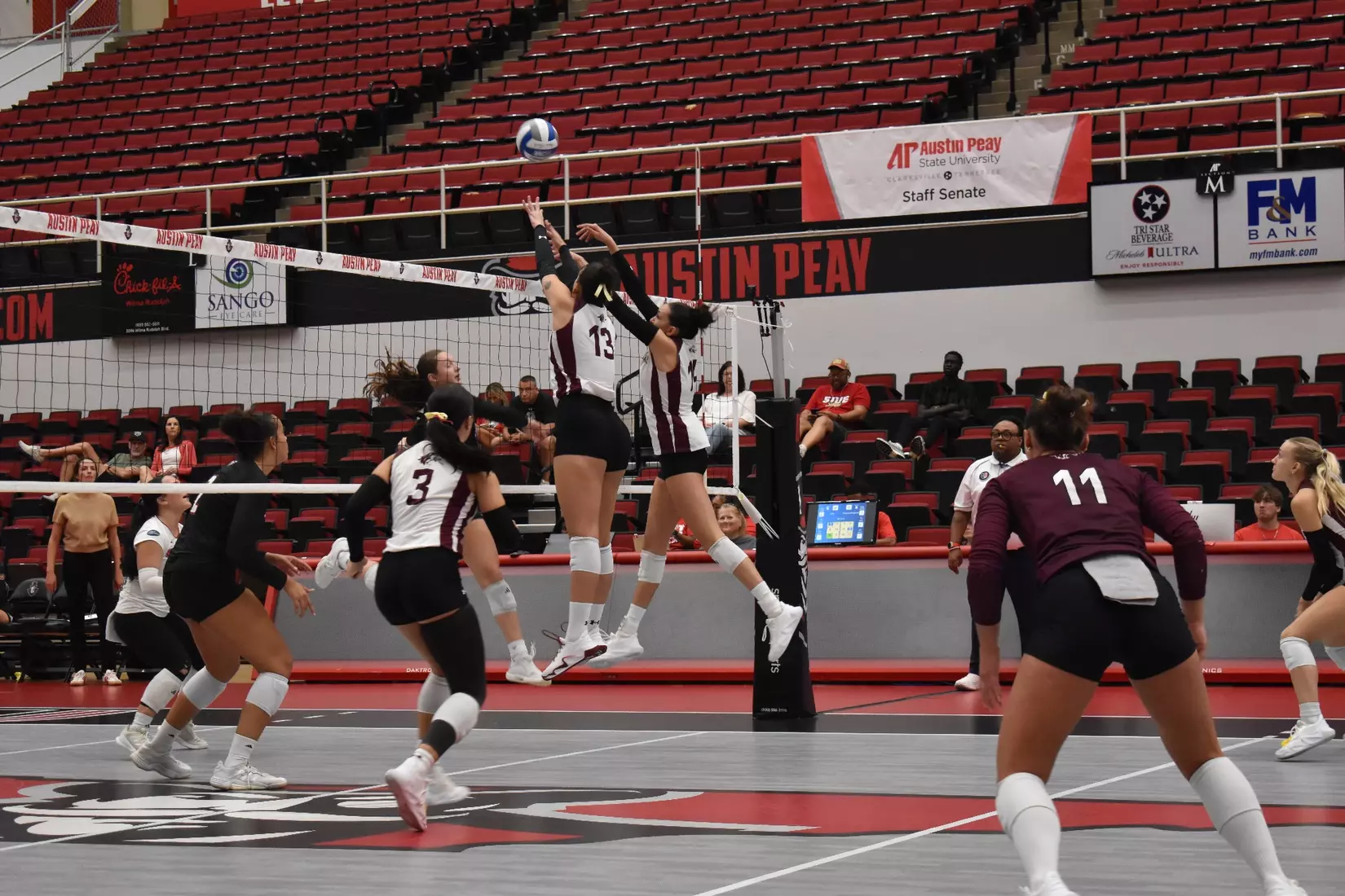 Beatriz Piaia and Ella Swansiger block a ball.