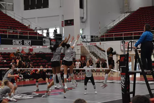 Chloe Anderson and Ella Swansiger go up for a block on an opposing attack.