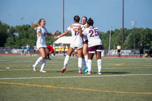 Salukis celebrating during the exhibition match
