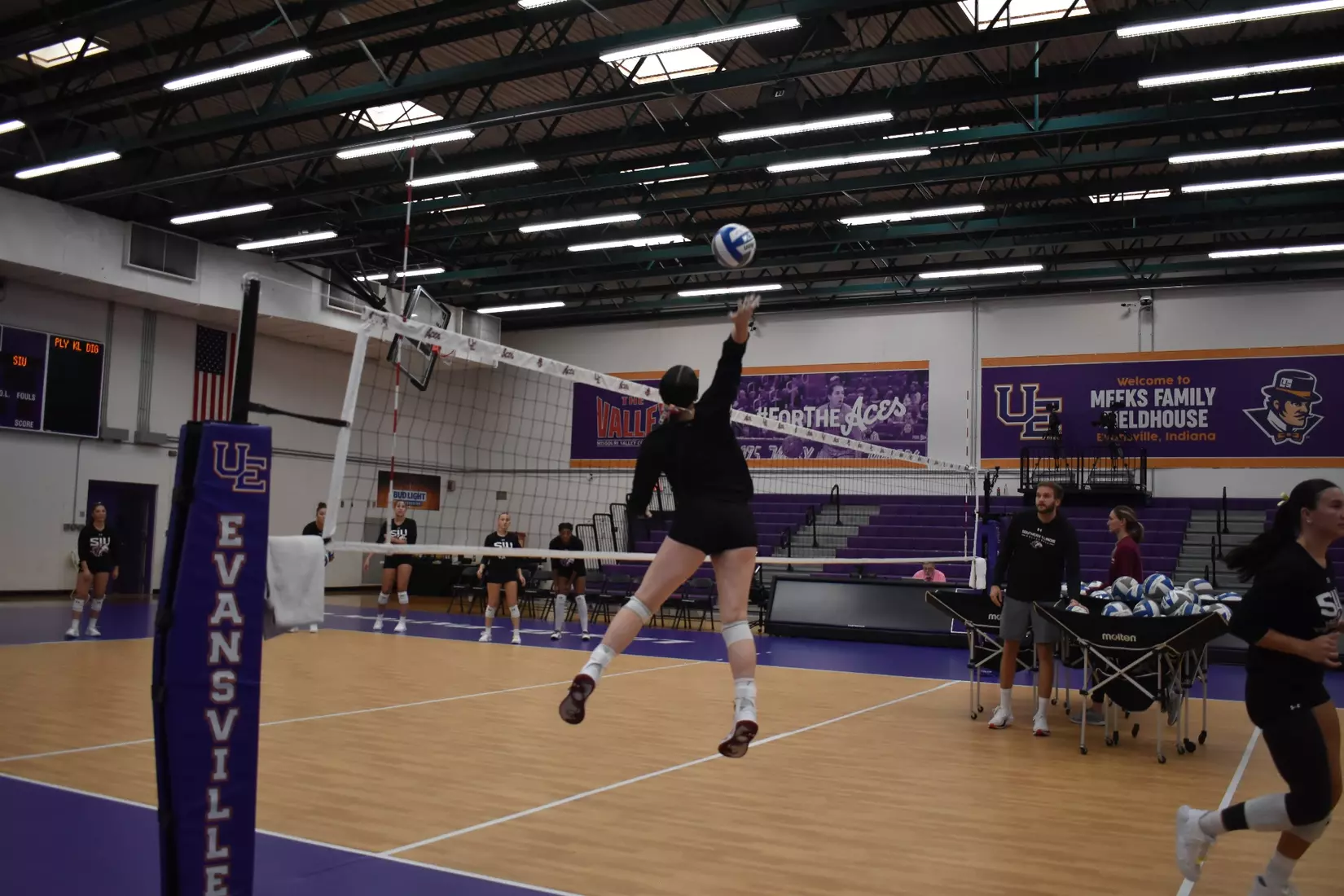 Alexandria Arrington attacks a ball in warmups.