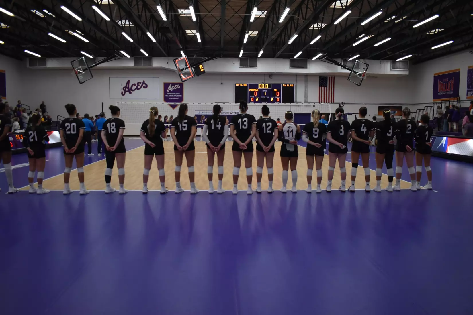 The team stands side by side during the National Anthem.