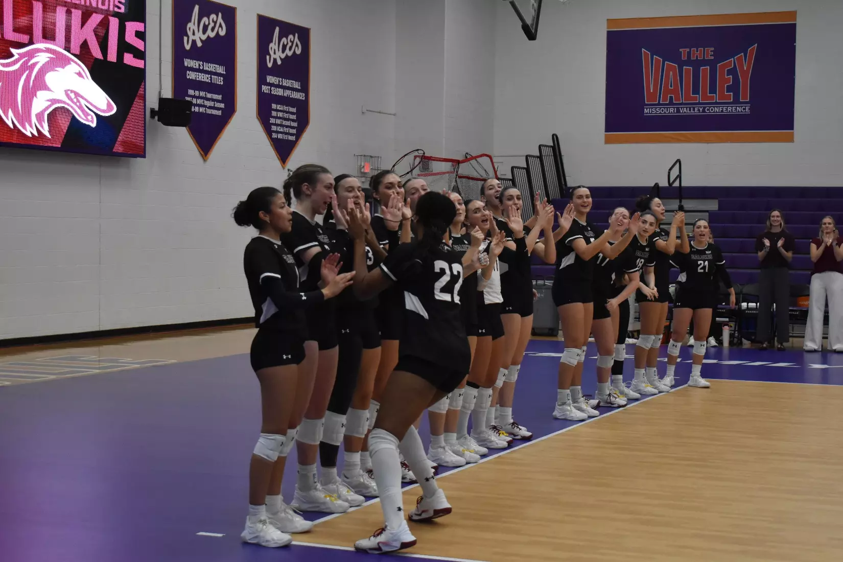 Chloe Anderson high fives her teammates as her name is announced.