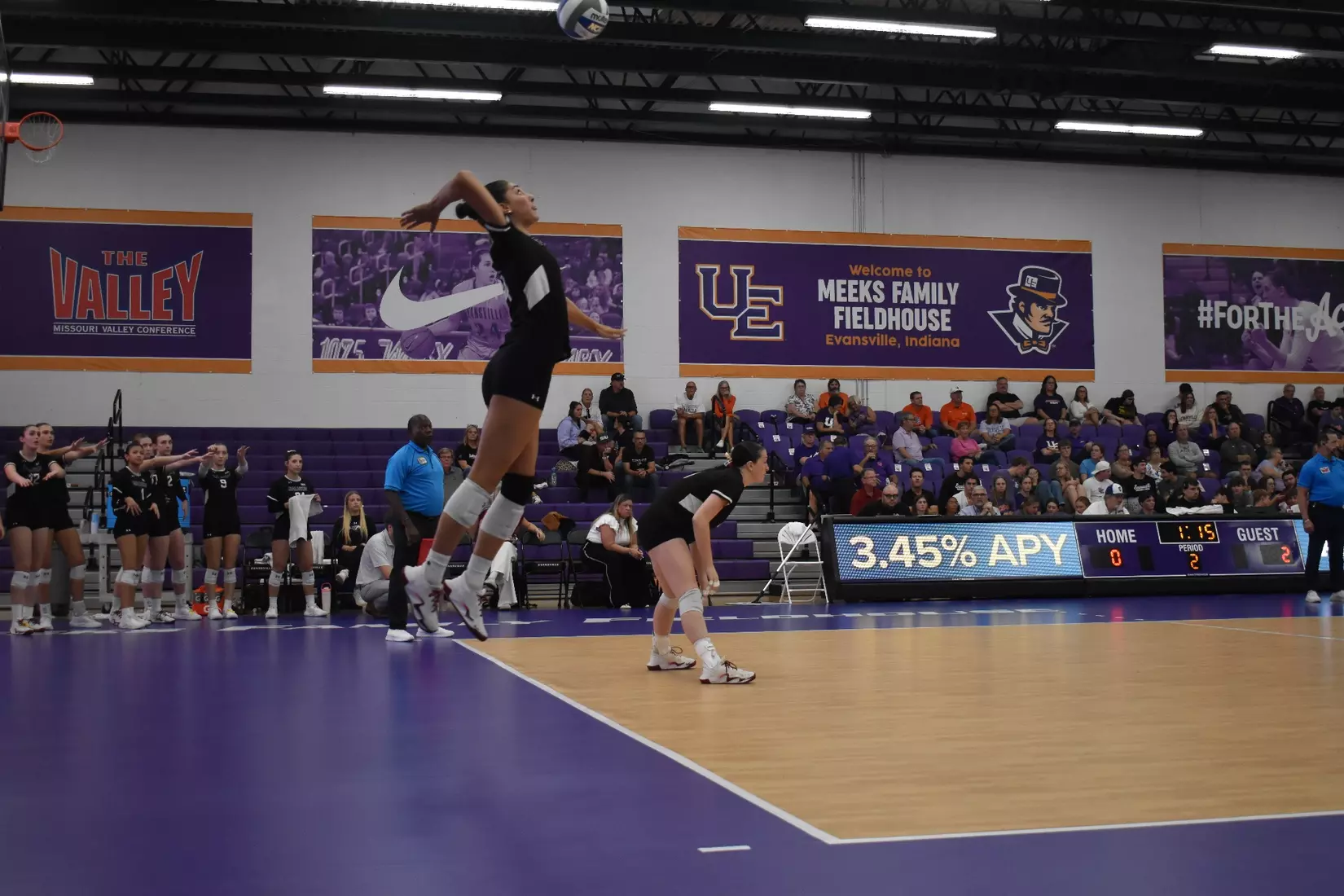 Ella McFarland goes up for a serve.