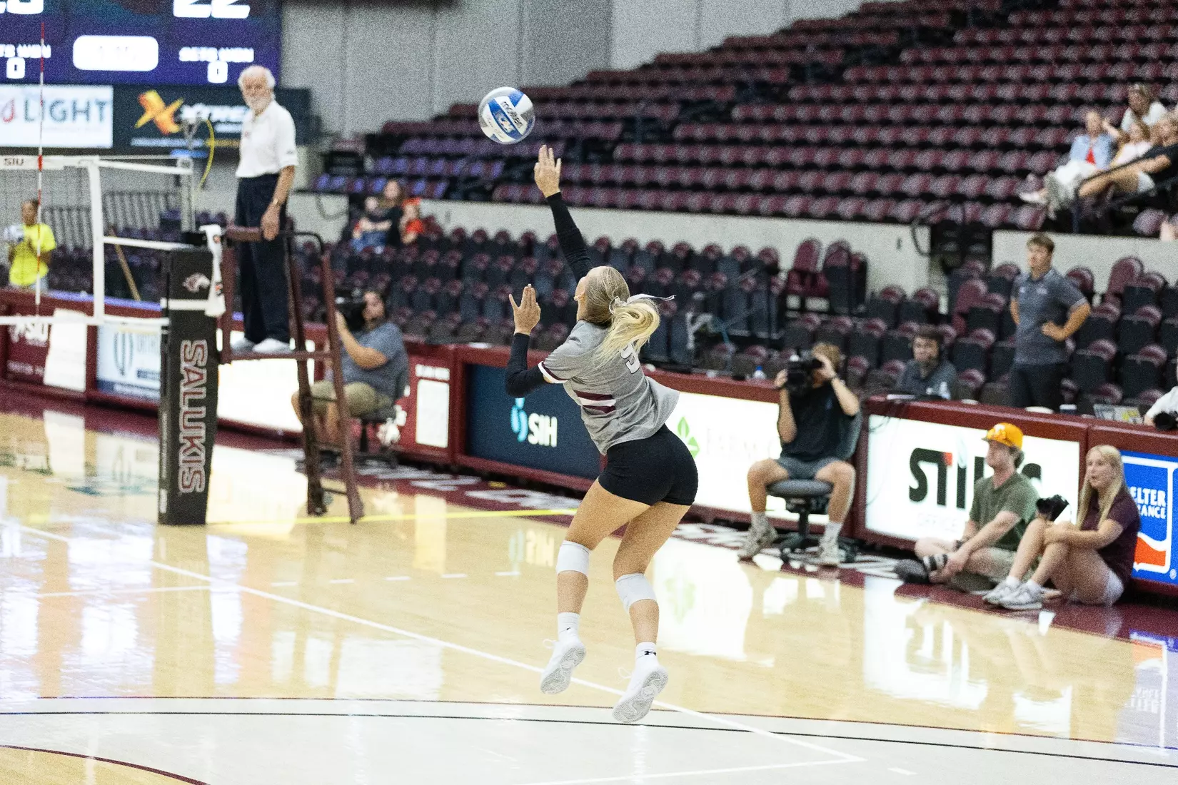 Lillian Dempkey serves a ball in the match.