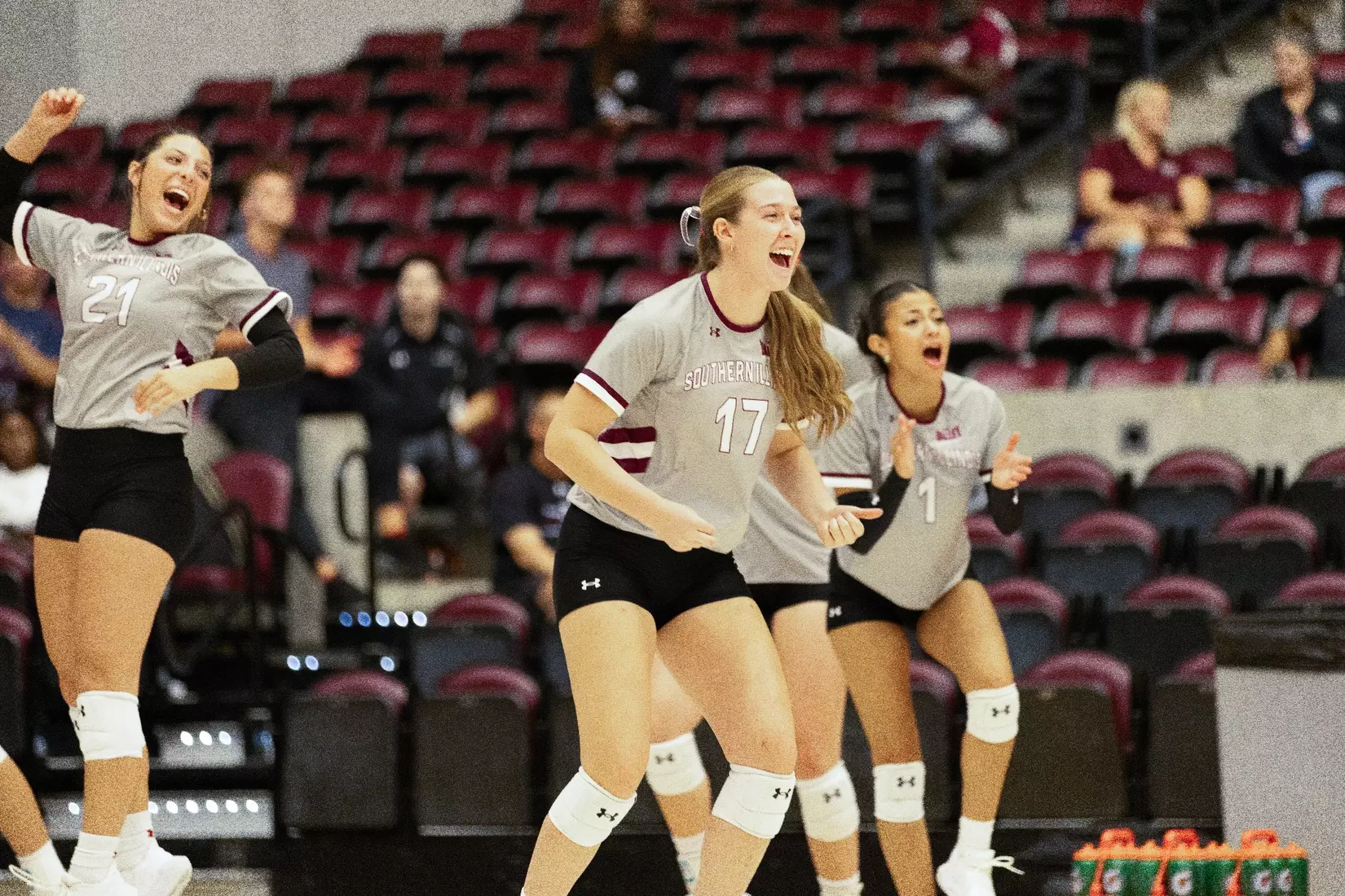 Julia Laidig leads the bench in celebration after a point.