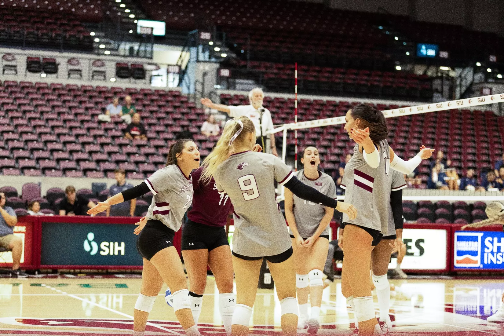 The team on the floor screams and celebrates after a point.