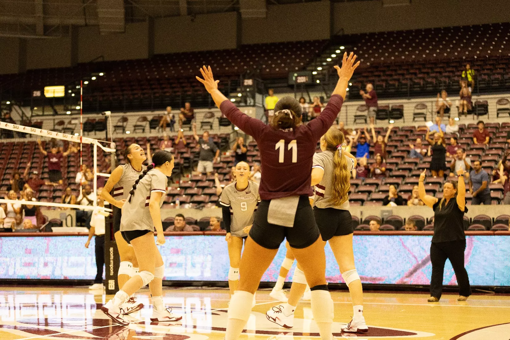Jillian Shaneyfelt throws her hands up in celebration.
