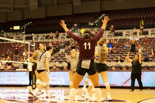 Jillian Shaneyfelt throws her hands up in celebration.