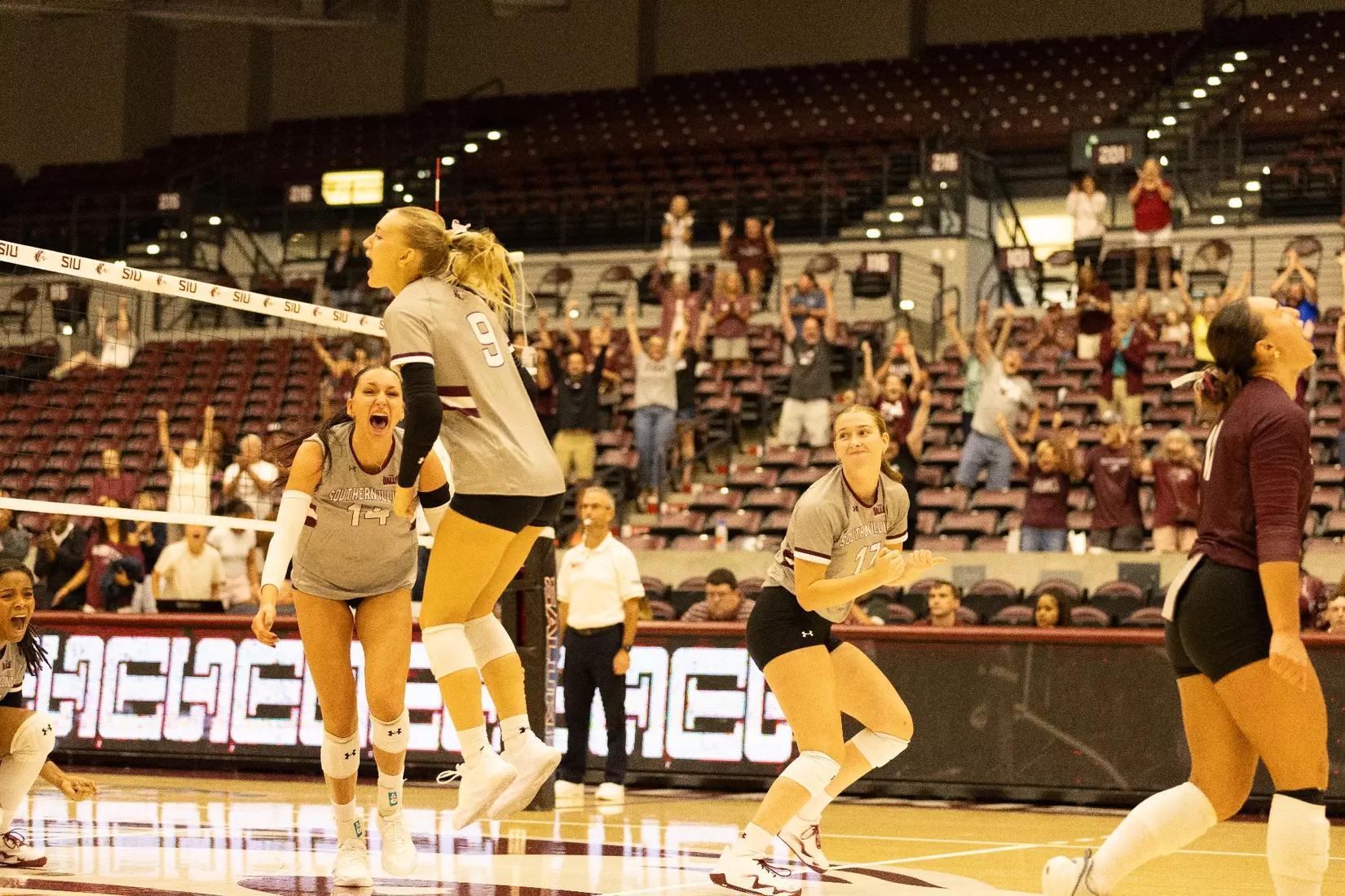 The team jumps and celebrates after winning the match.