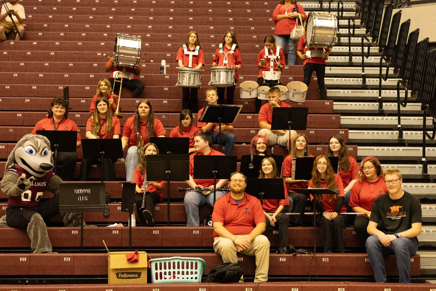 The Sandoval pep band and Grey Dawg smile for a picture.