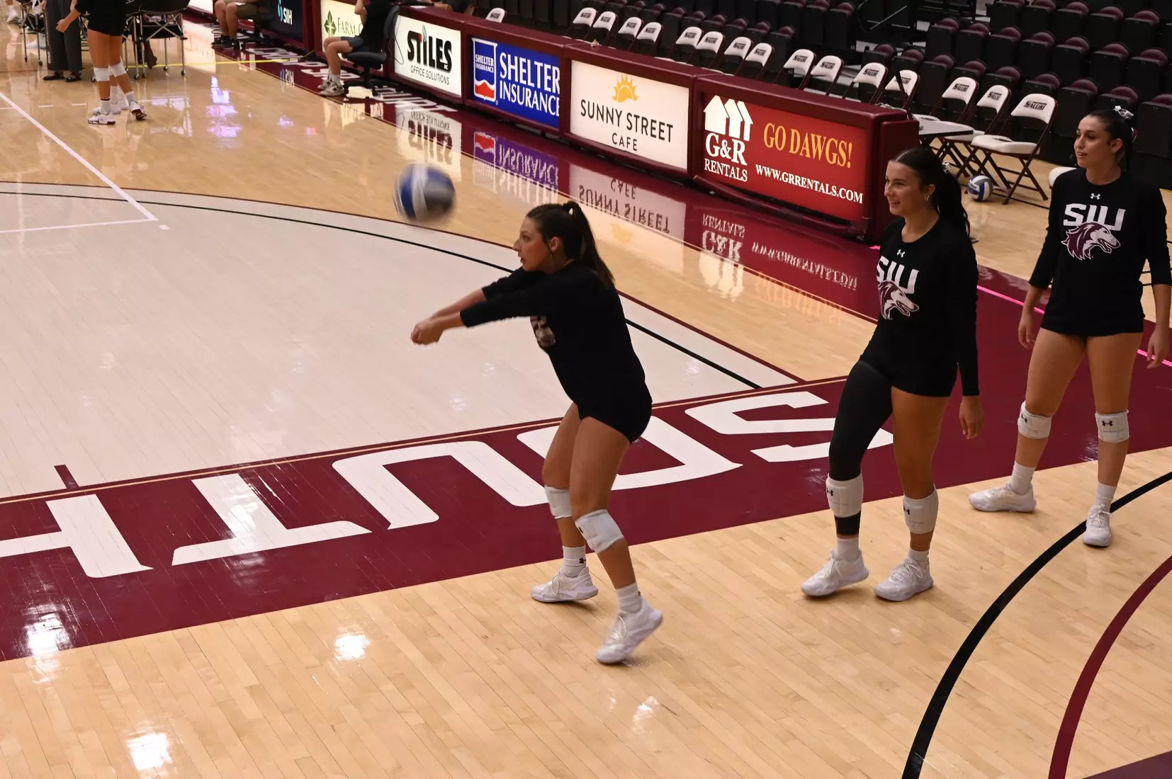 Isabella Del Real bumps a ball in warmups.