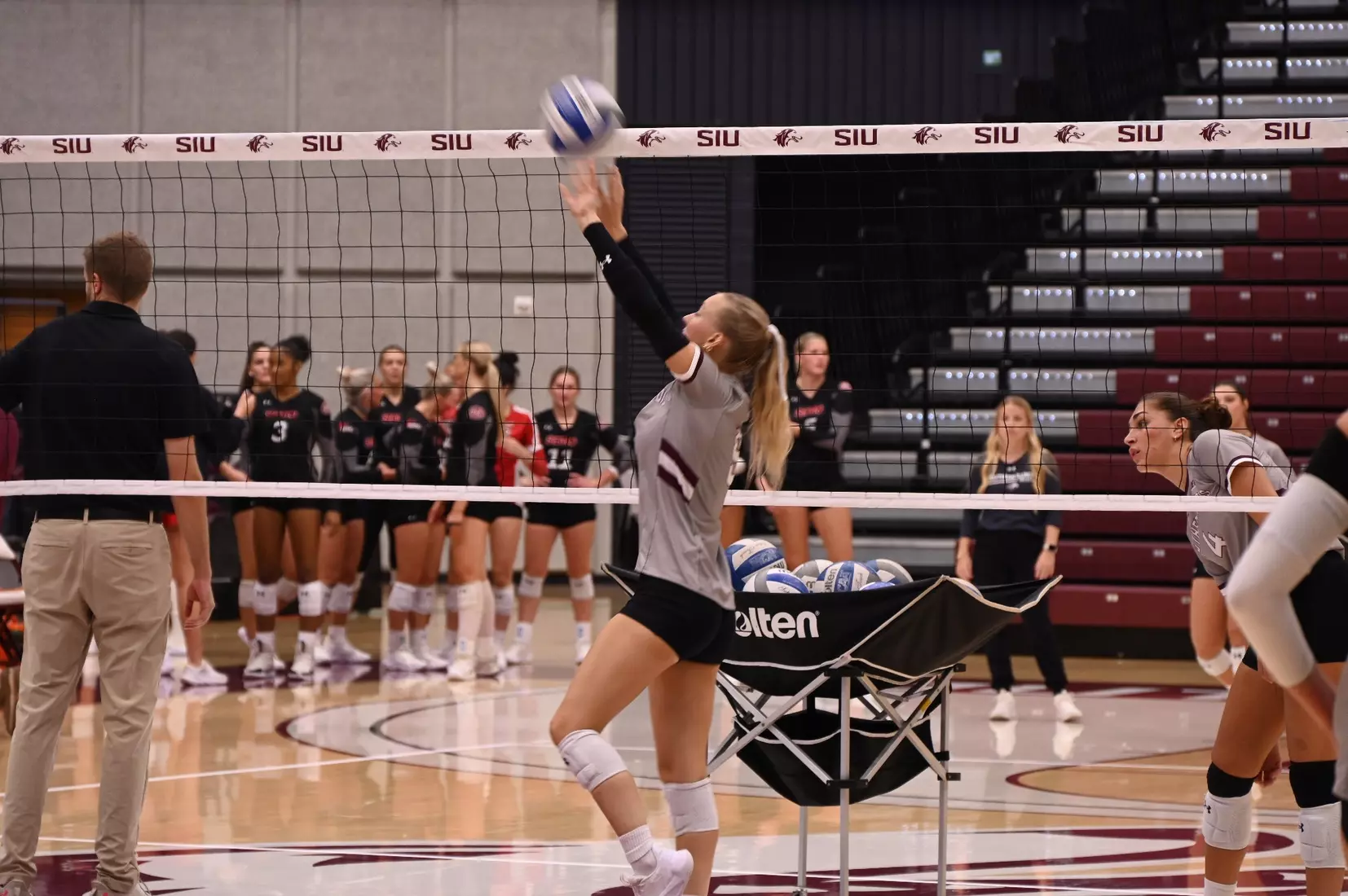 Lillian Dempkey sets a ball in warmups.