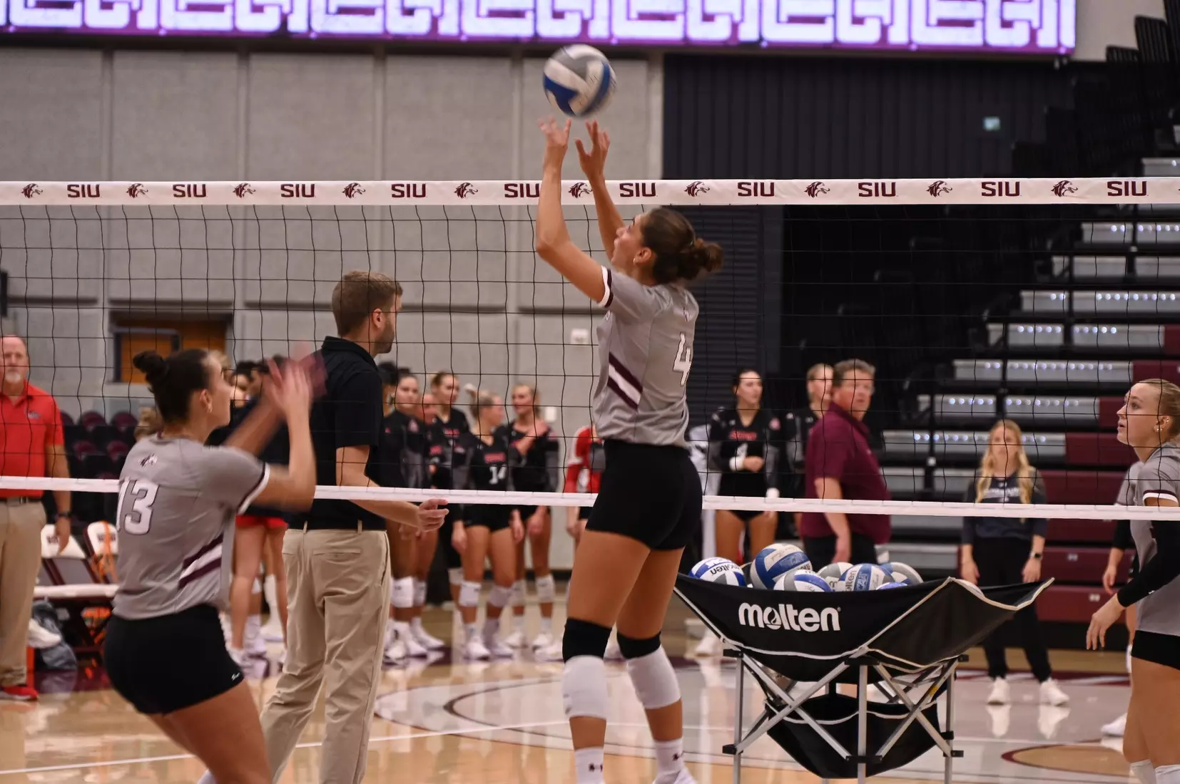 Ella McFarland sets a ball in warmups.