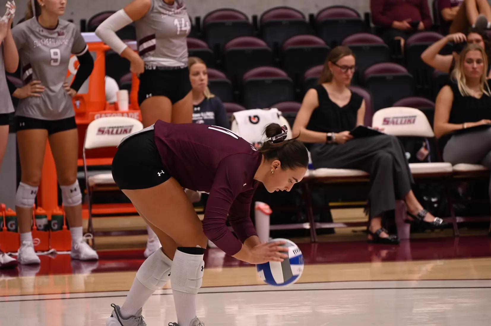 Jillian Shaneyfelt dribbles the ball prior to her serve.