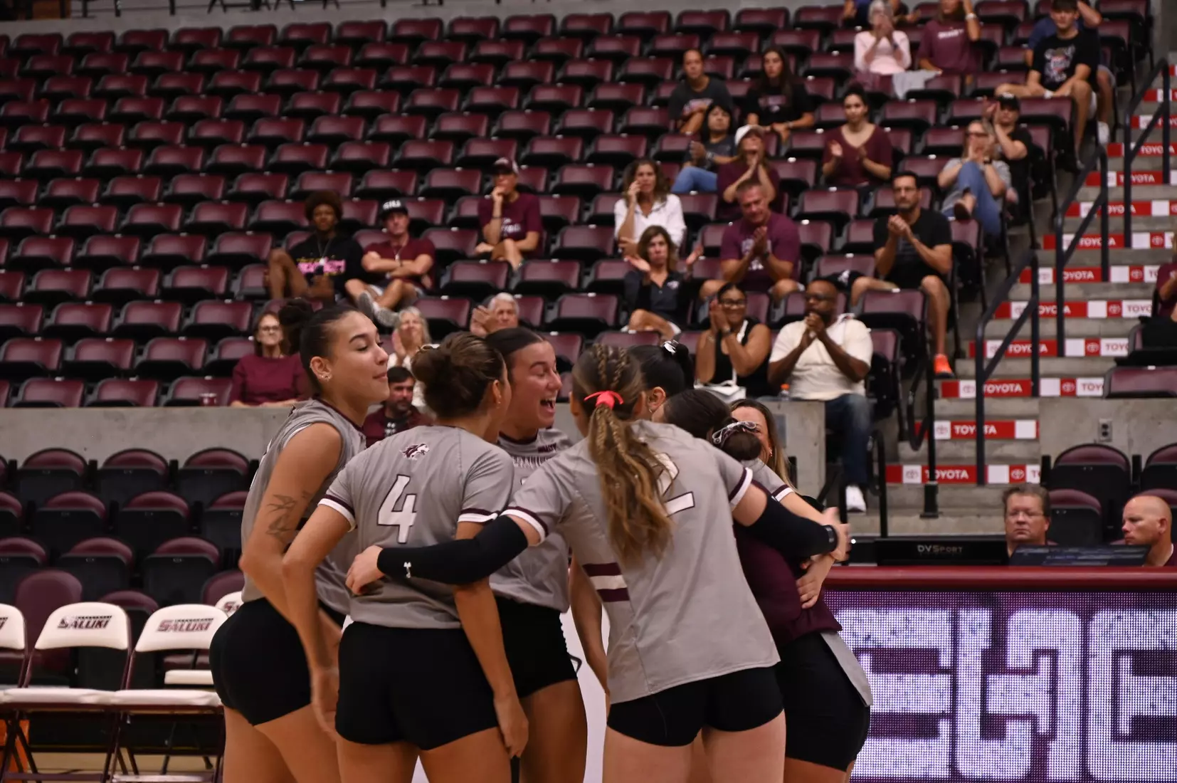 The team on the floor huddles after a point.