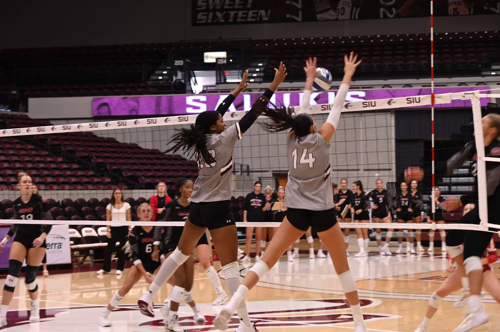 Chloe Anderson and Ella Swansiger jump up for a tandem block.