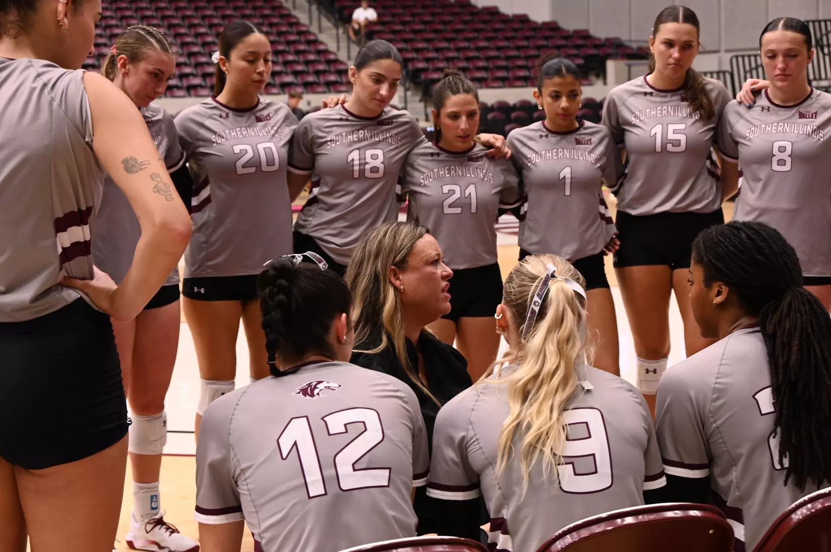Head Coach Brittany Harry talks to her team during a timeout.