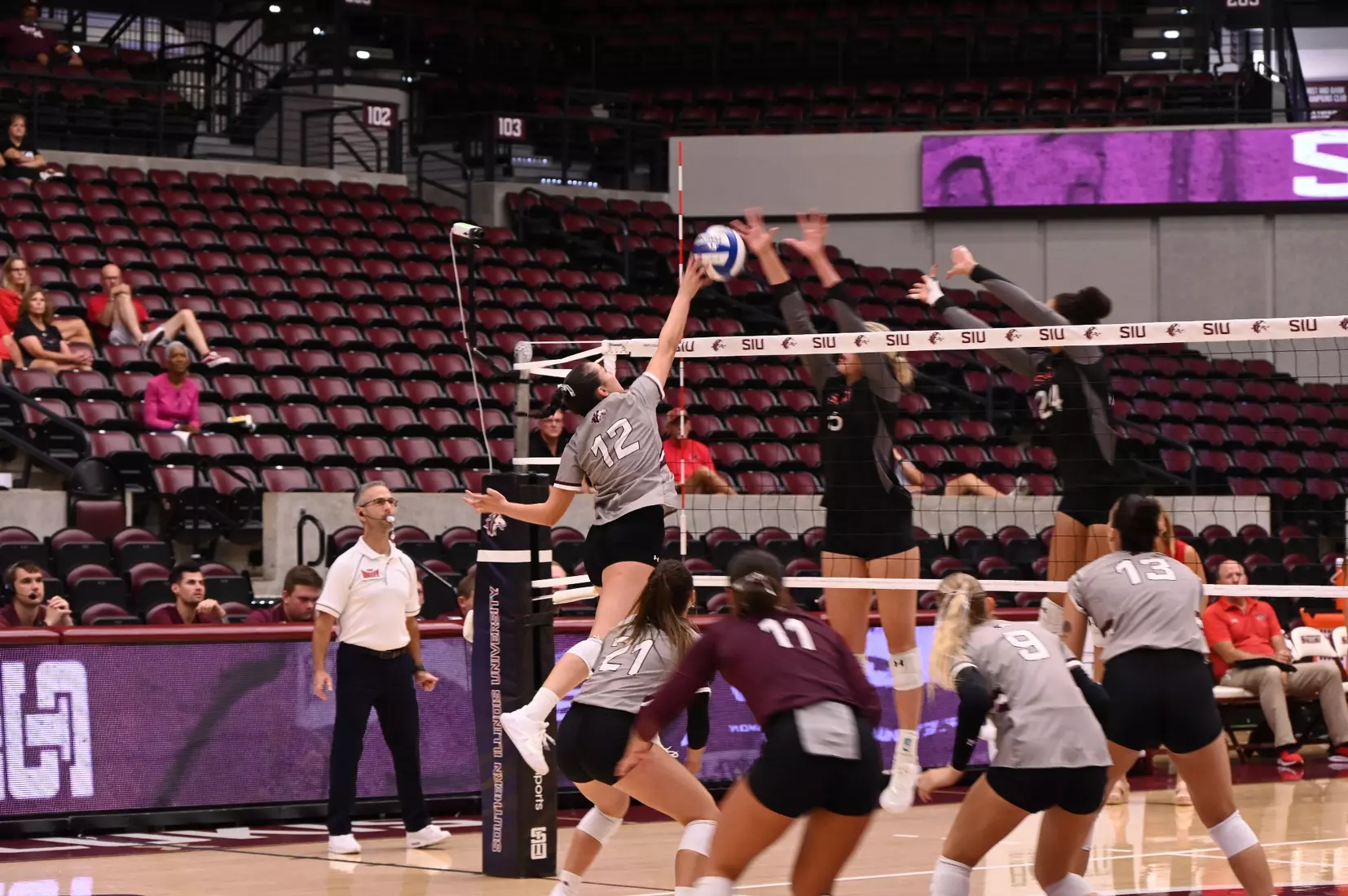 Carlota Mora tips a ball over the net.
