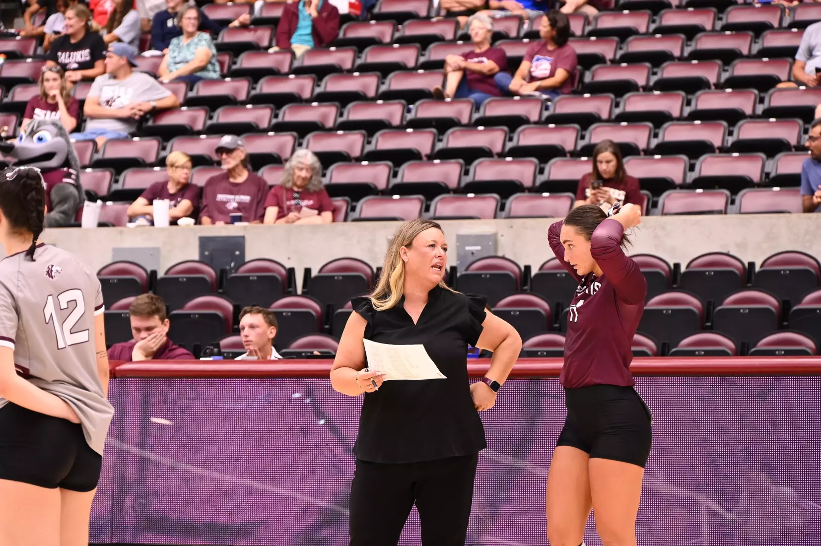 Head Coach Brittany Harry talks with senior libero Jillian Shaneyfelt.