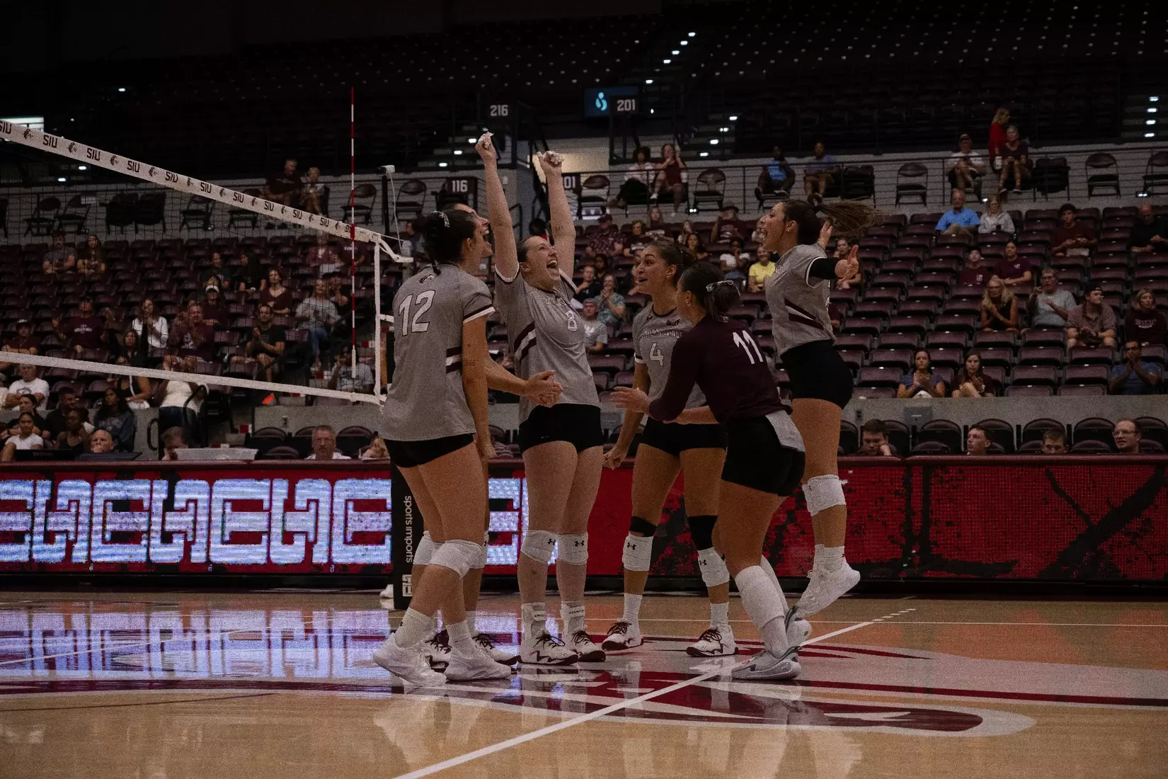 The team celebrates in excitement after a point.